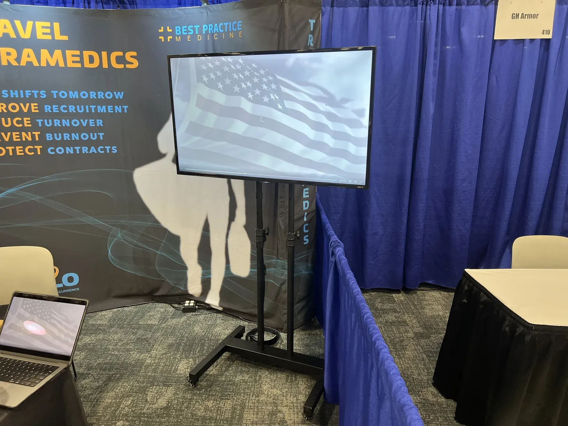 Conference booth with TV display and American flag at Nashville trade show