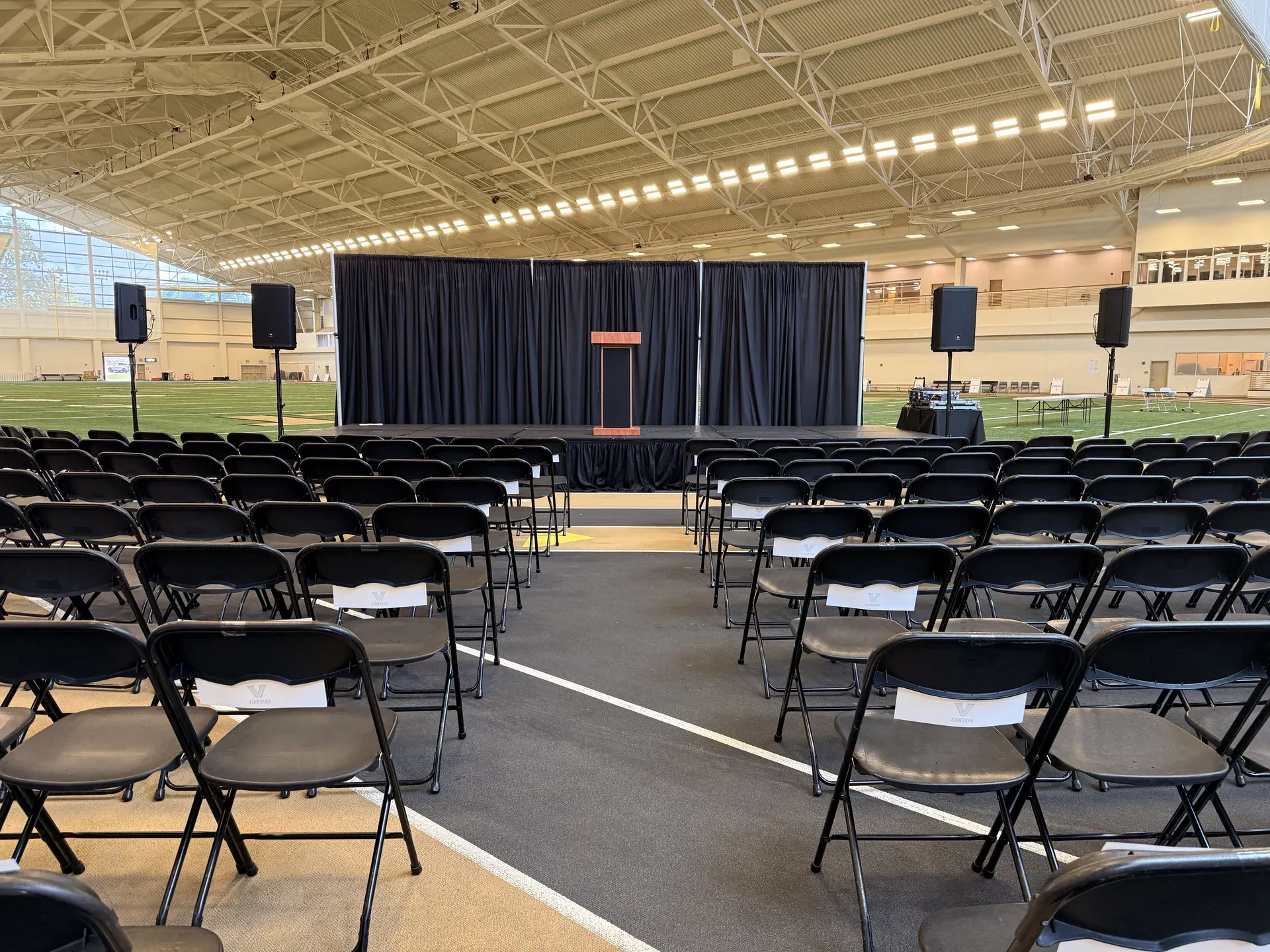 Large conference stage with podium and PA speaker system at Nashville event venue