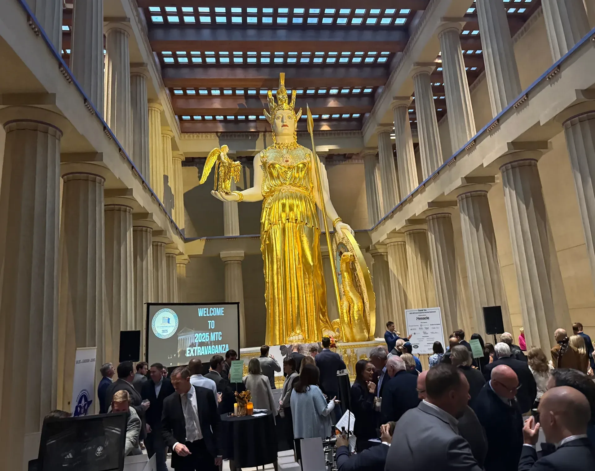Corporate gala with audio and projection setup at venue with Athena statue in Nashville