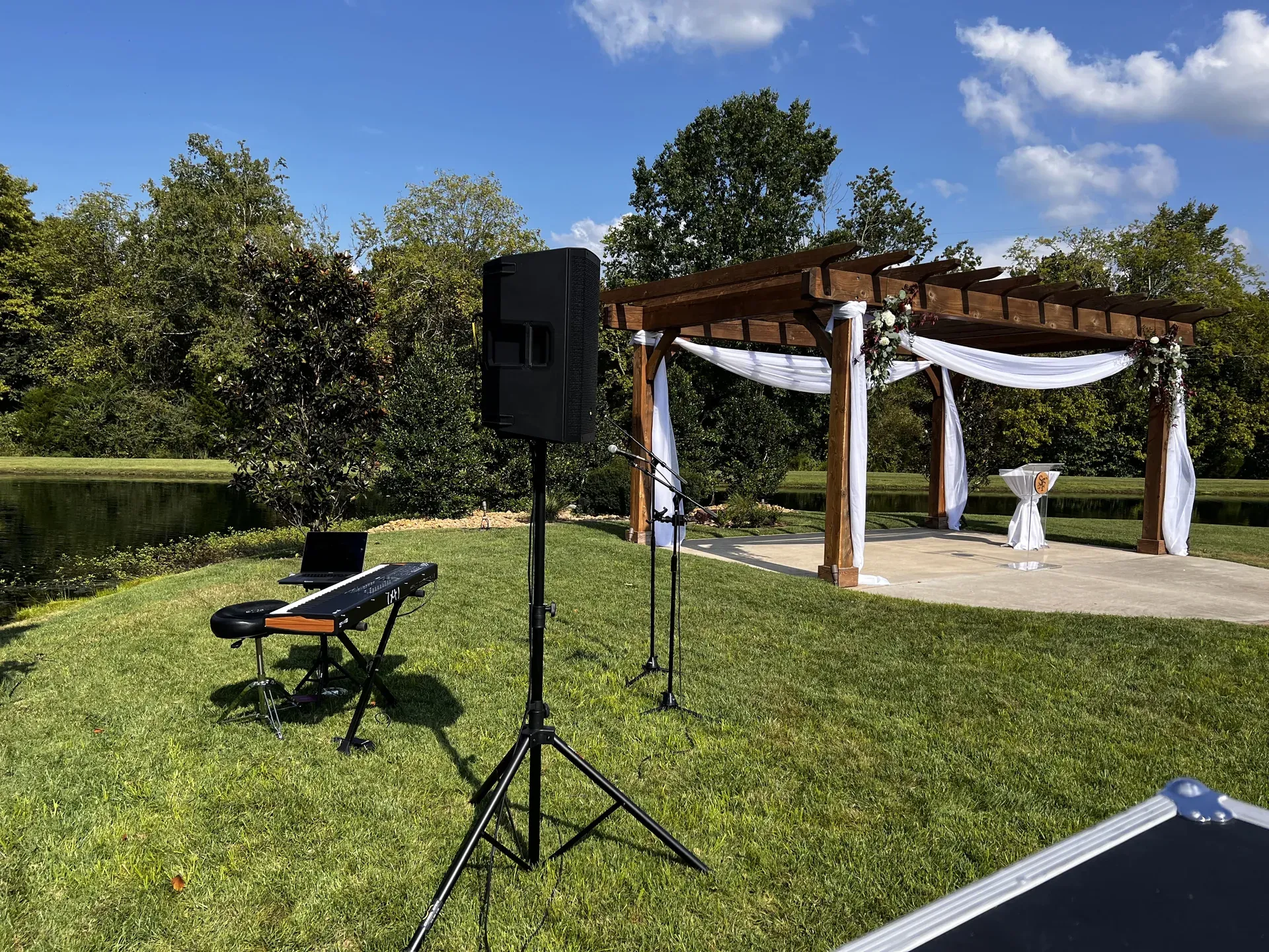 Lakeside wedding ceremony with PA speaker and keyboard setup