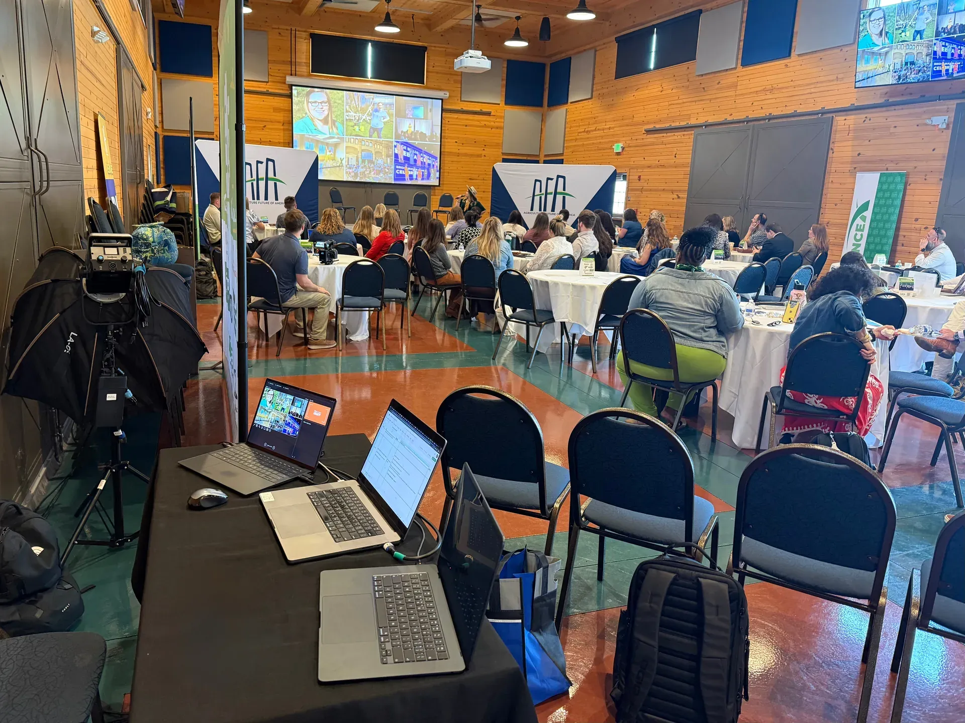 Nashville AV production at corporate event with round tables and projection screen