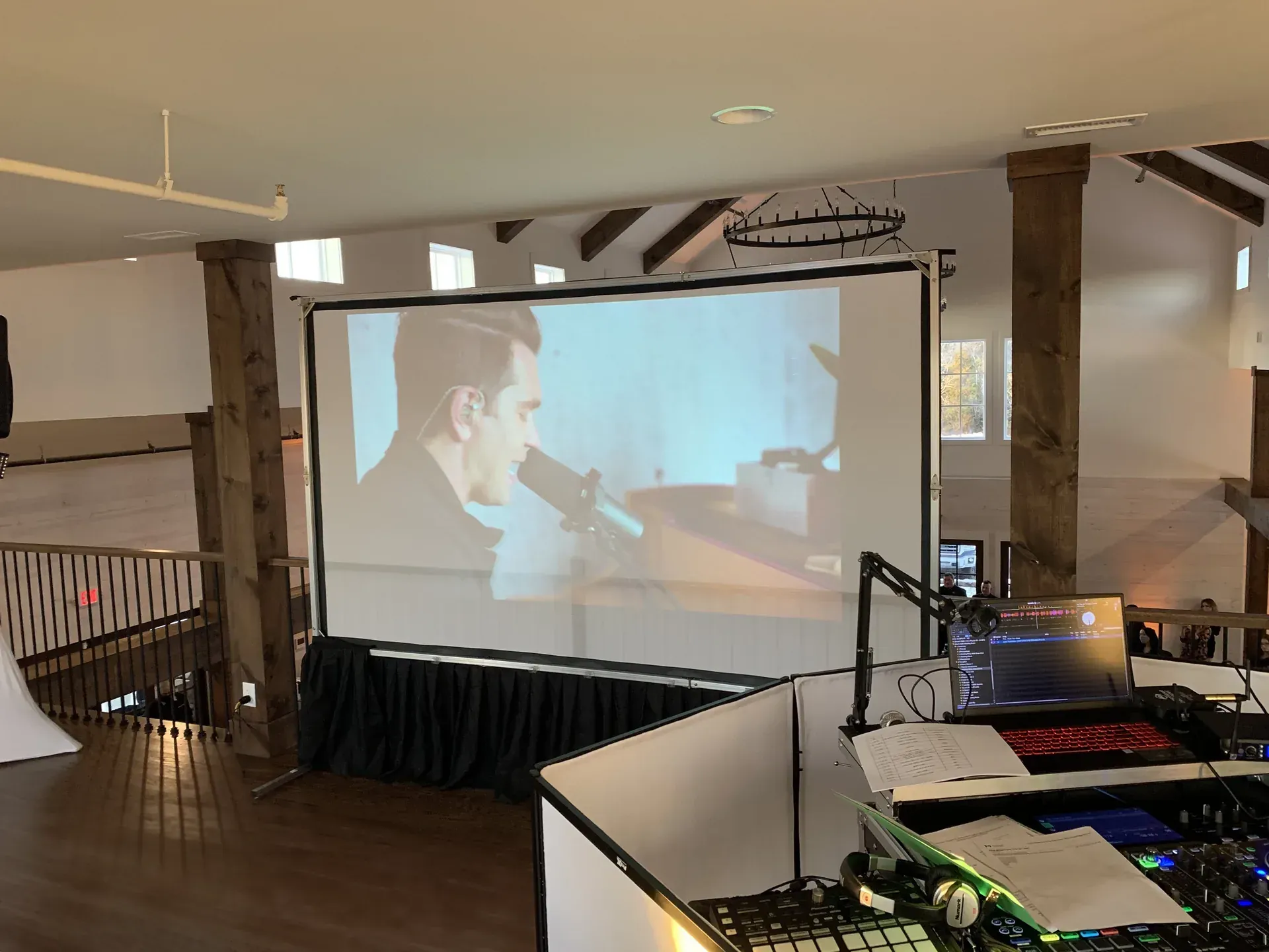 Rustic venue projection screen setup for wedding reception in Middle Tennessee