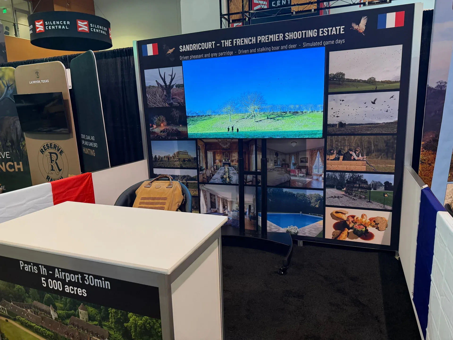 Large trade show booth with multiple TV displays and multimedia wall for Nashville expo