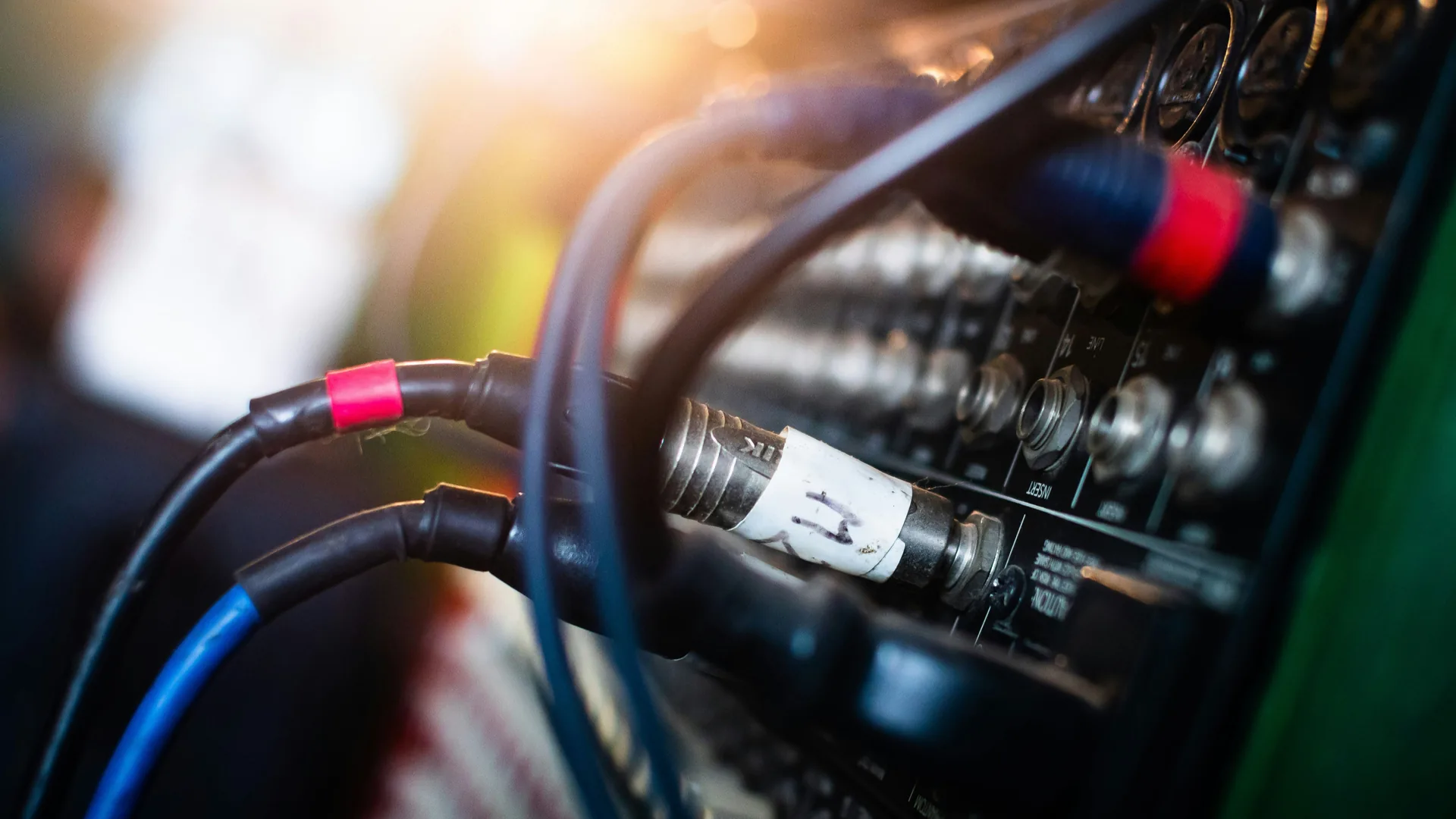 Audio cables connected to mixer showing signal flow for troubleshooting during live events