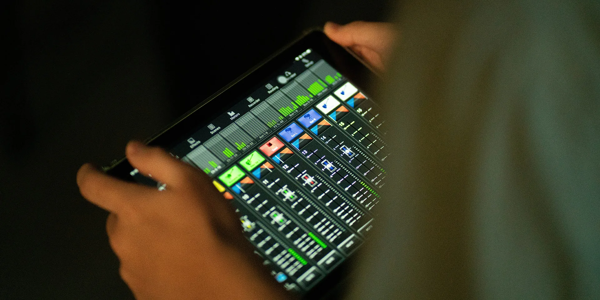Digital audio mixer interface displayed on tablet showing multiple channels and live sound levels