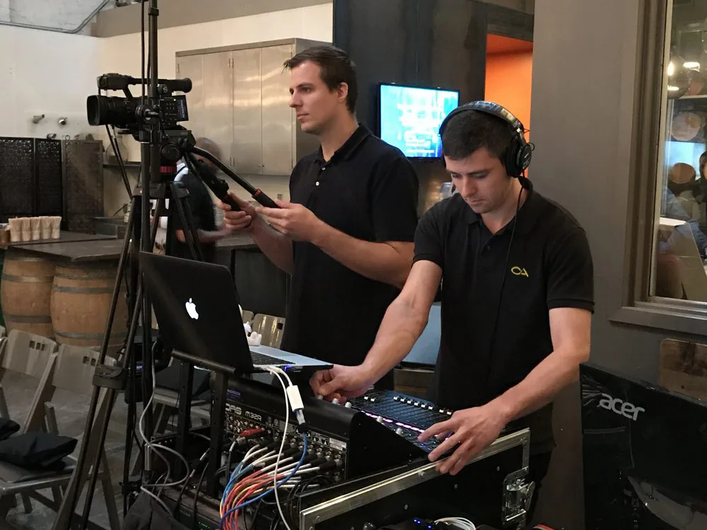 Audio engineer operating mixing console during live event production