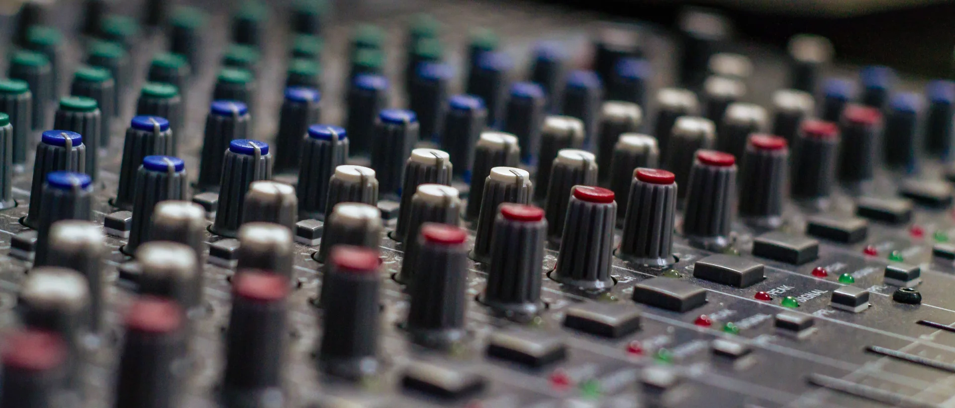Audio mixer close up knobs — channel controls used during sound board setup and soundcheck