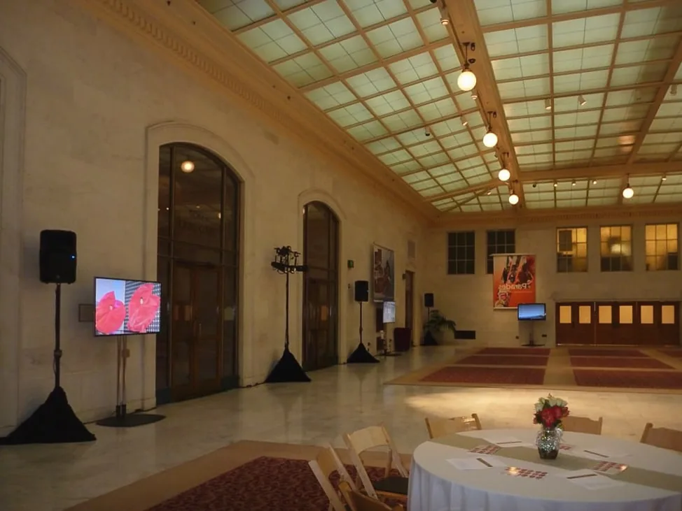 TV display and loudspeakers set up at a wedding reception for slideshow and audio
