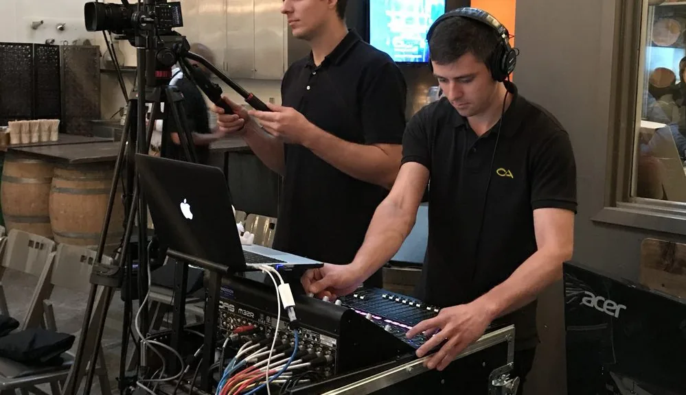 Professional AV technician operating audio equipment at event