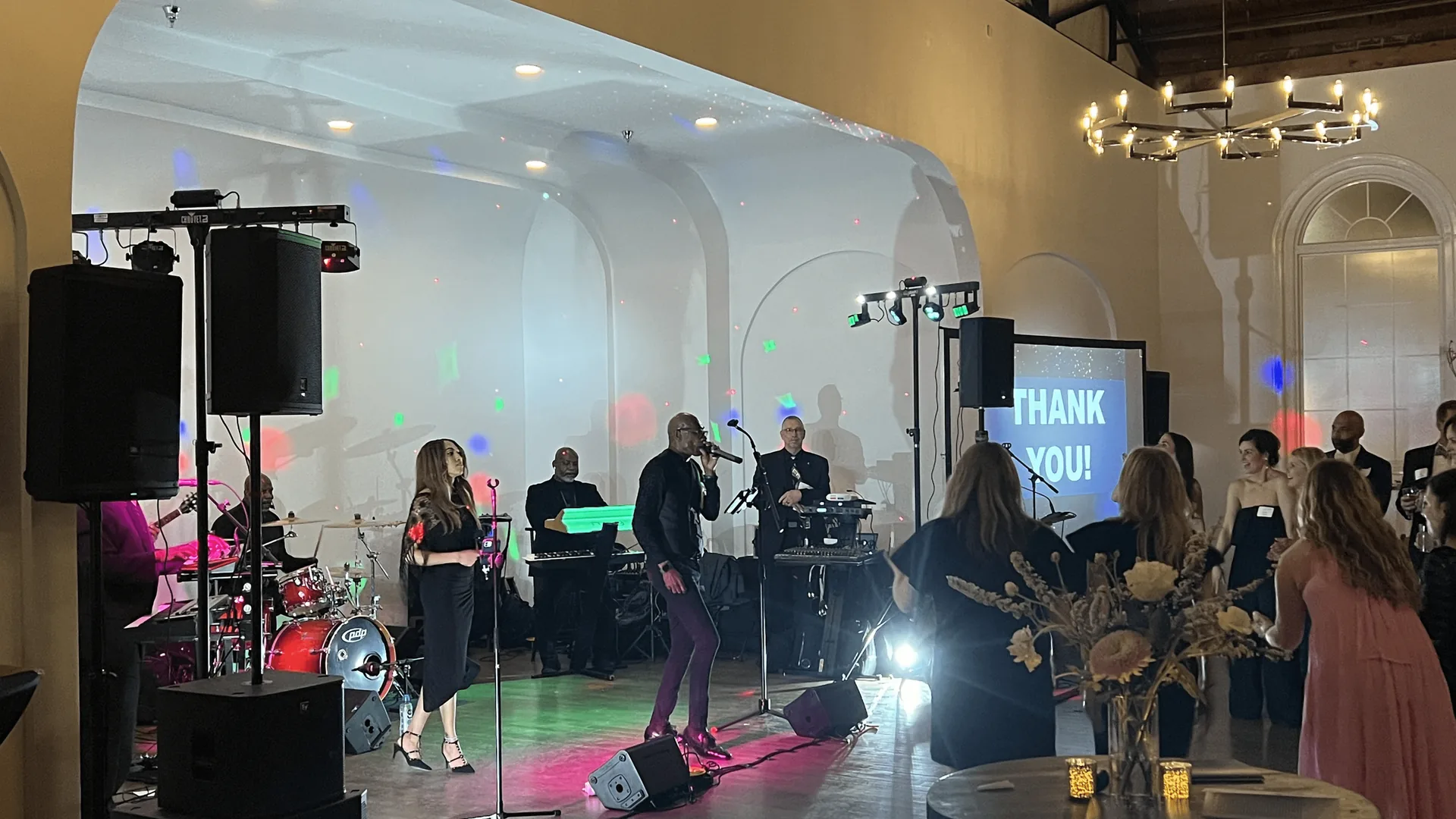 Band performing on stage at Emerson Hall in Nashville with wireless microphones and PA speakers
