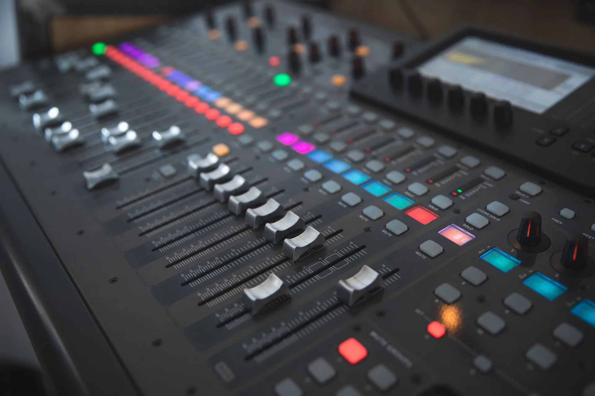 Behringer X32 digital mixing console faders used for live event audio
