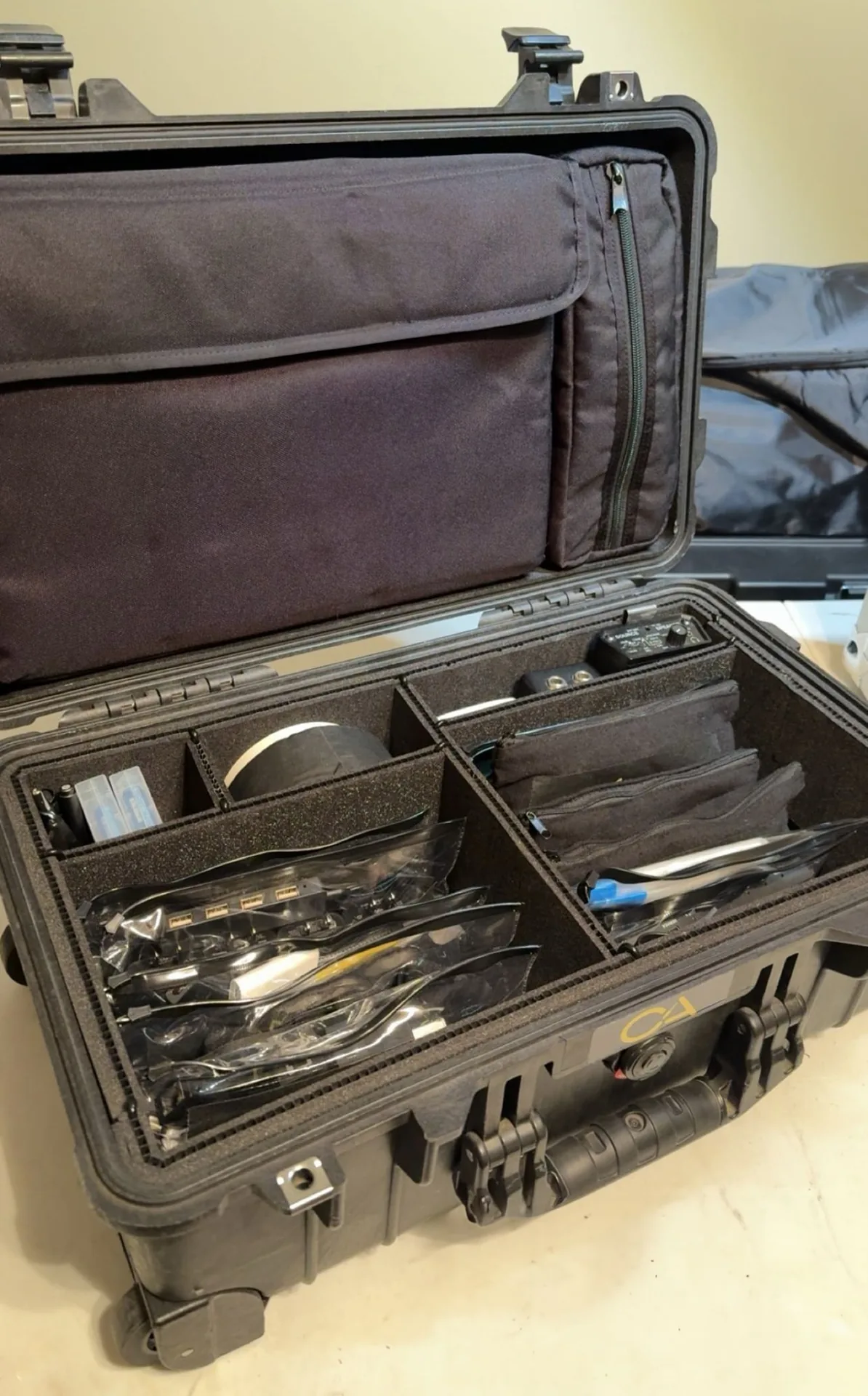 Organized work box filled with labeled cables, adapters, and essential AV accessories for events