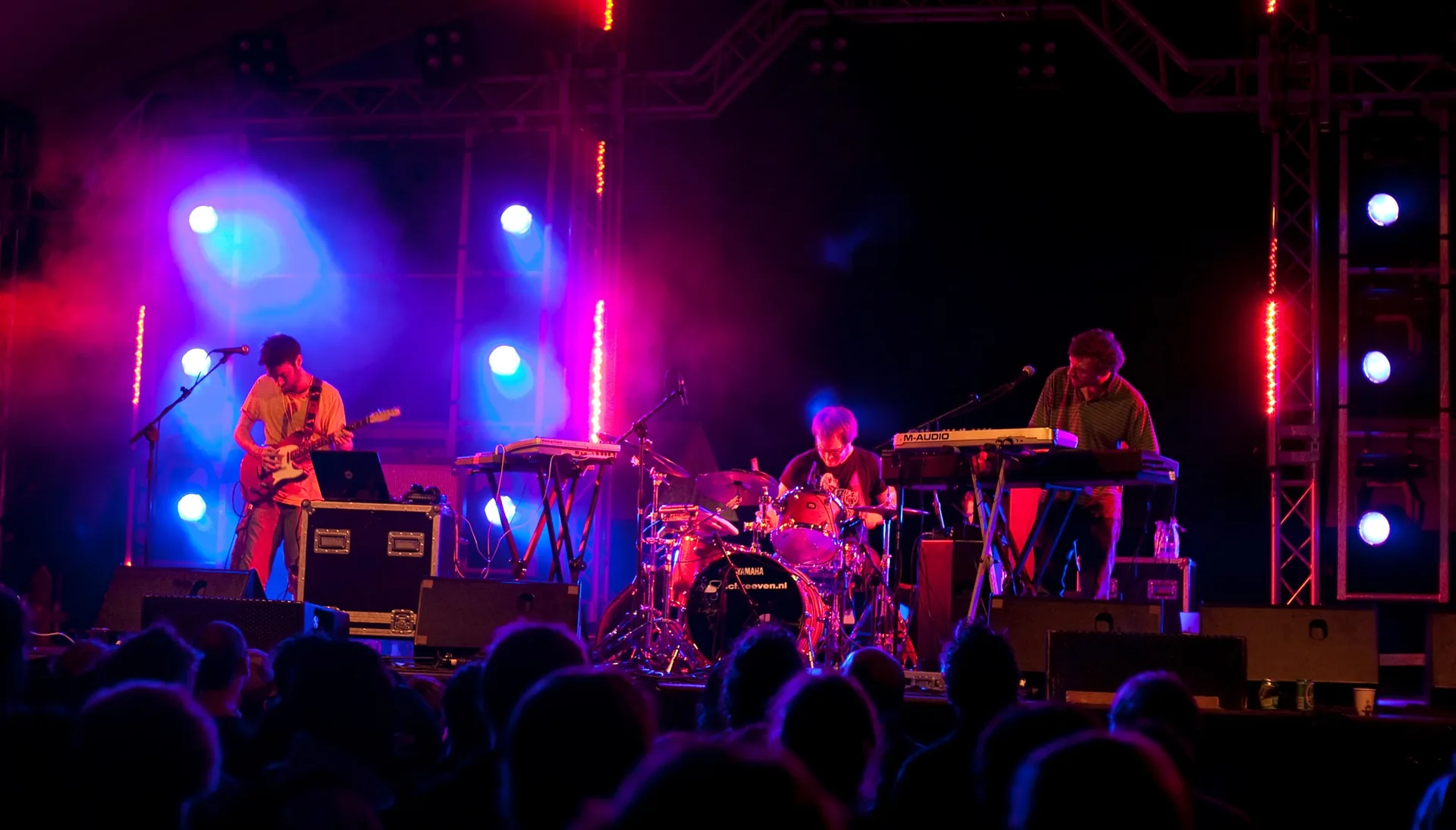 Concert production crew at front of house mixing position during a live performance