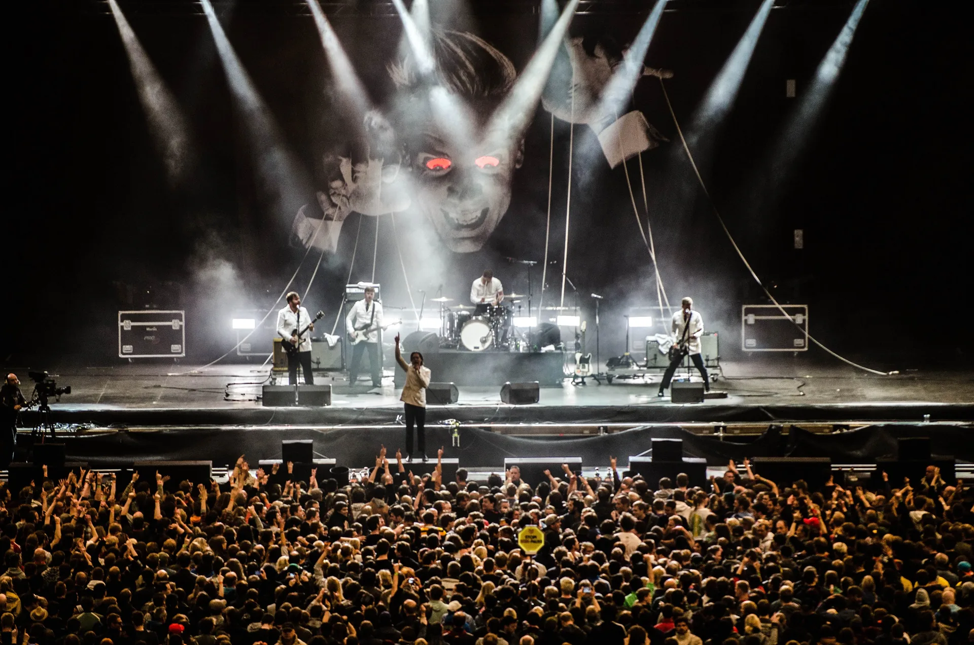 Large concert venue stage setup with multiple floor wedge speaker monitors