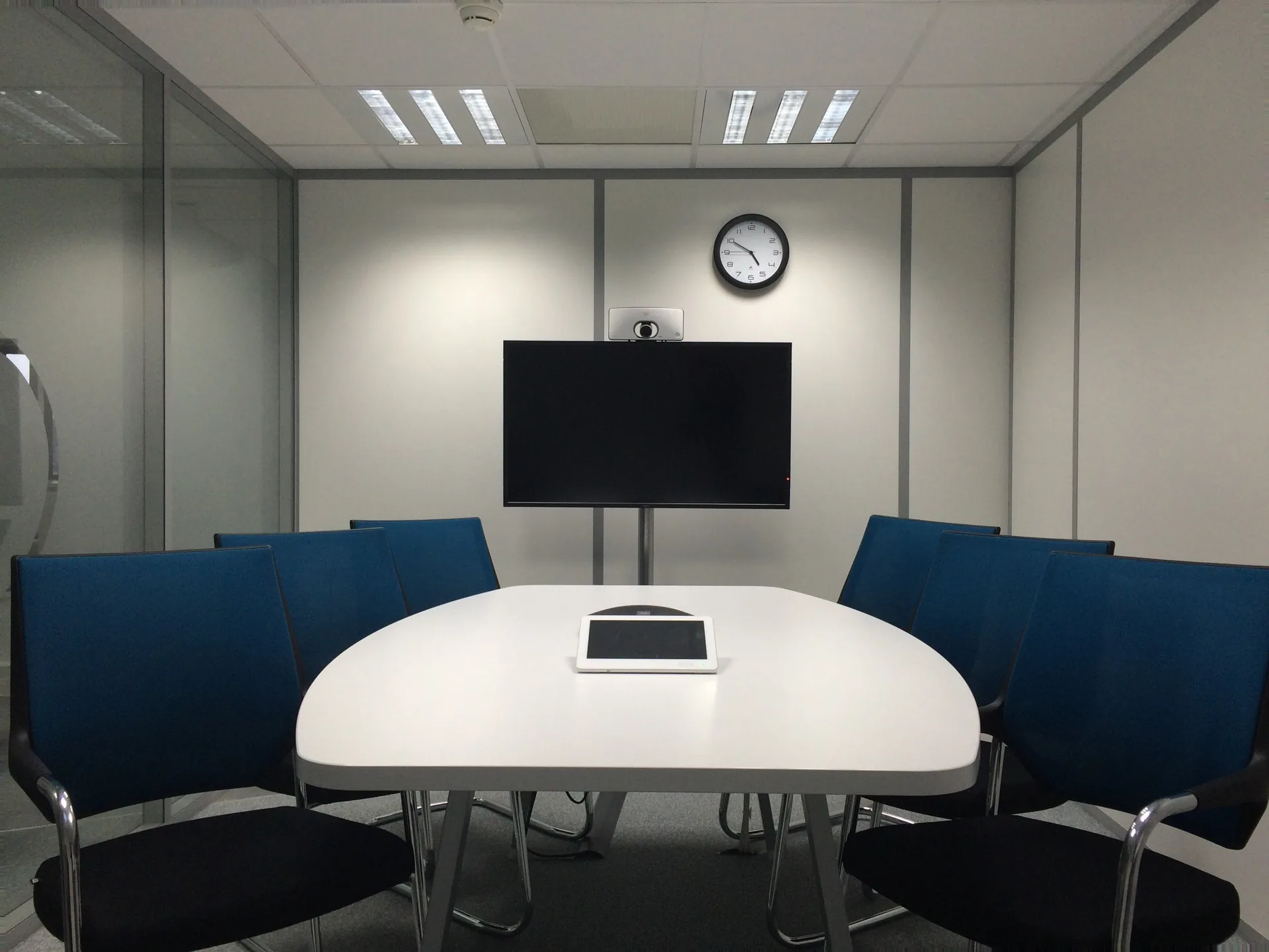 Conference room with a TV display at the front used for a corporate presentation