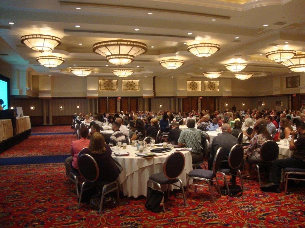 Corporate meeting setup with AV equipment including microphones and display screens in a conference room