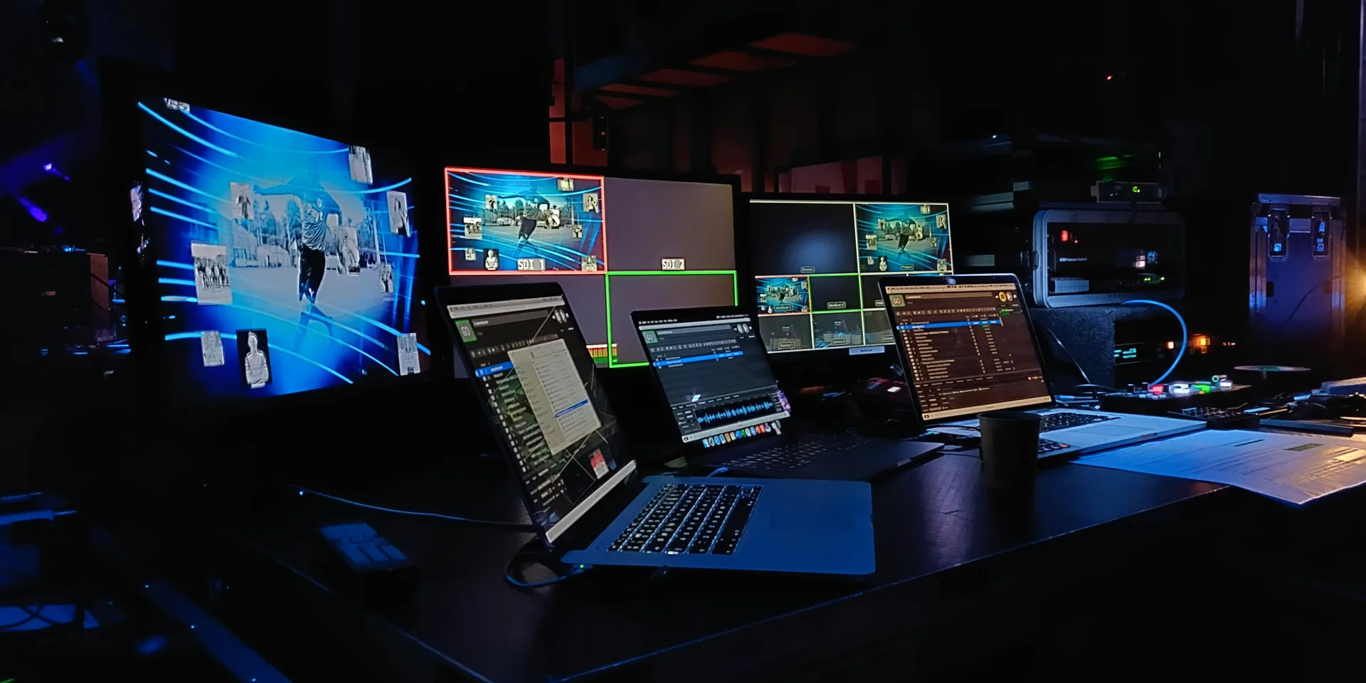 Live event control room with dedicated presentation laptop managing multiple presentation feeds
