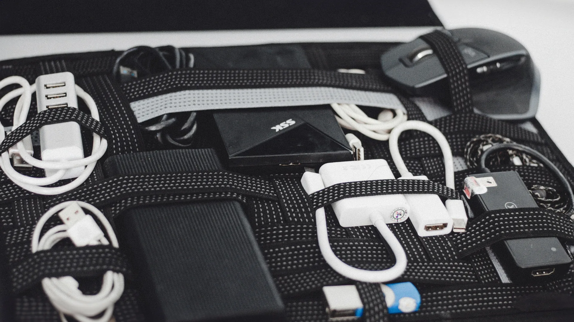 Assorted HDMI adapters, USB cables, and AV dongles organized for quick device connections