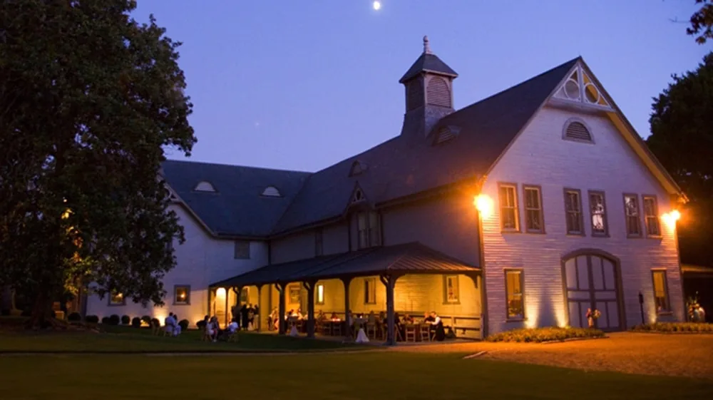Illuminated Belle Meade Plantation exterior with guests dining outside under starry sky
