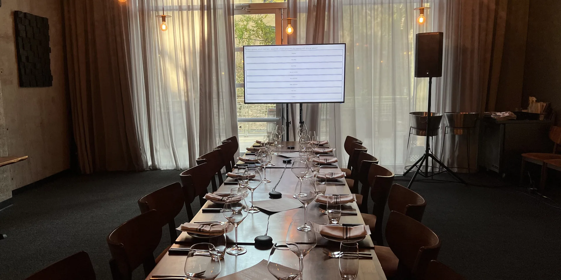 Private dinner event with presentation screen, table microphones and professional audio recording setup