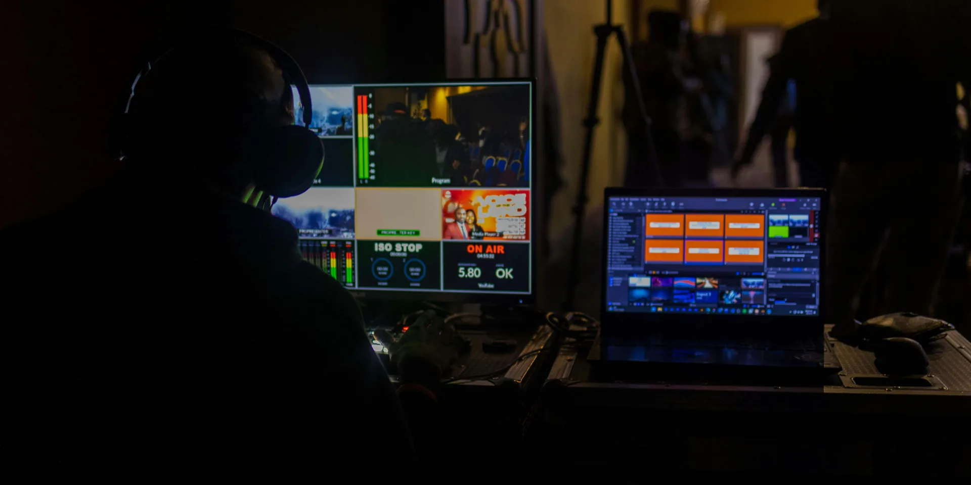 AV technician operating presentation laptop and video switching system during live event