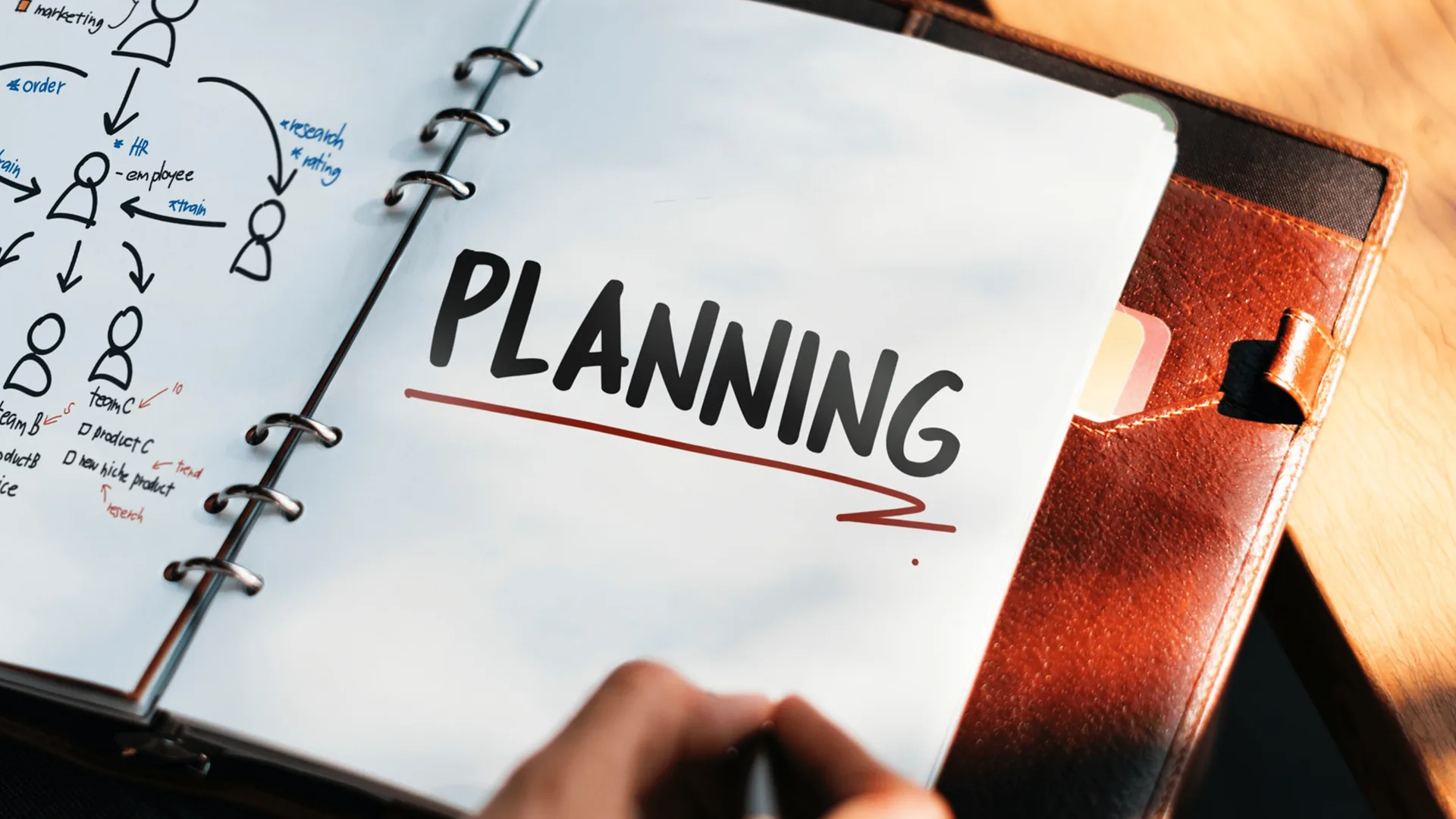 Open event planning binder with notes, checklist and planning materials