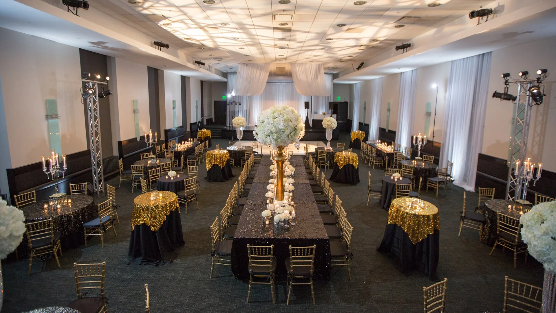 Frist Art Museum event setup with black and gold table settings and floral centerpieces