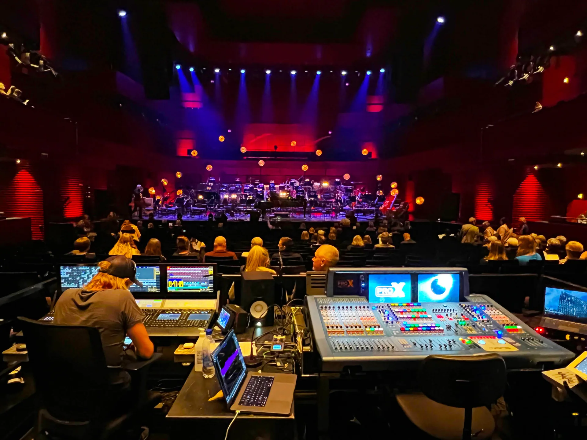 Front of house mixing console positioned with clear view of stage before live performance