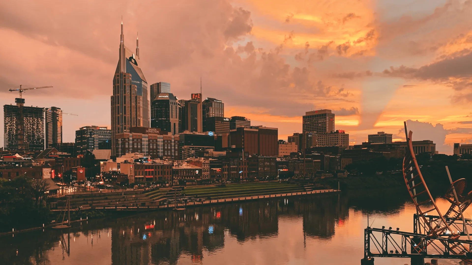 Golden sunset reflecting on Cumberland River with Nashville skyline in background
