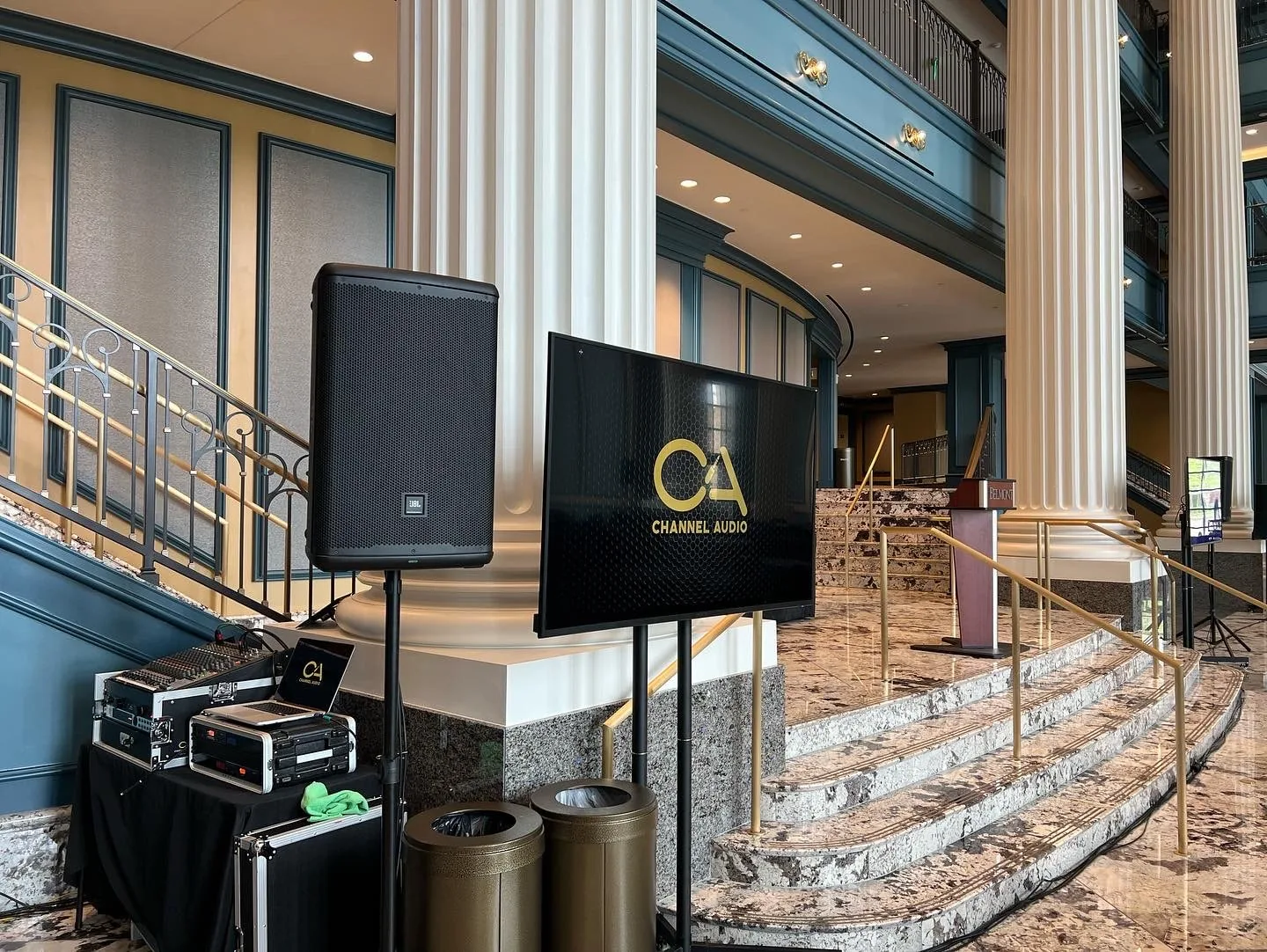 Professional AV setup in grand hall with lighting and display equipment