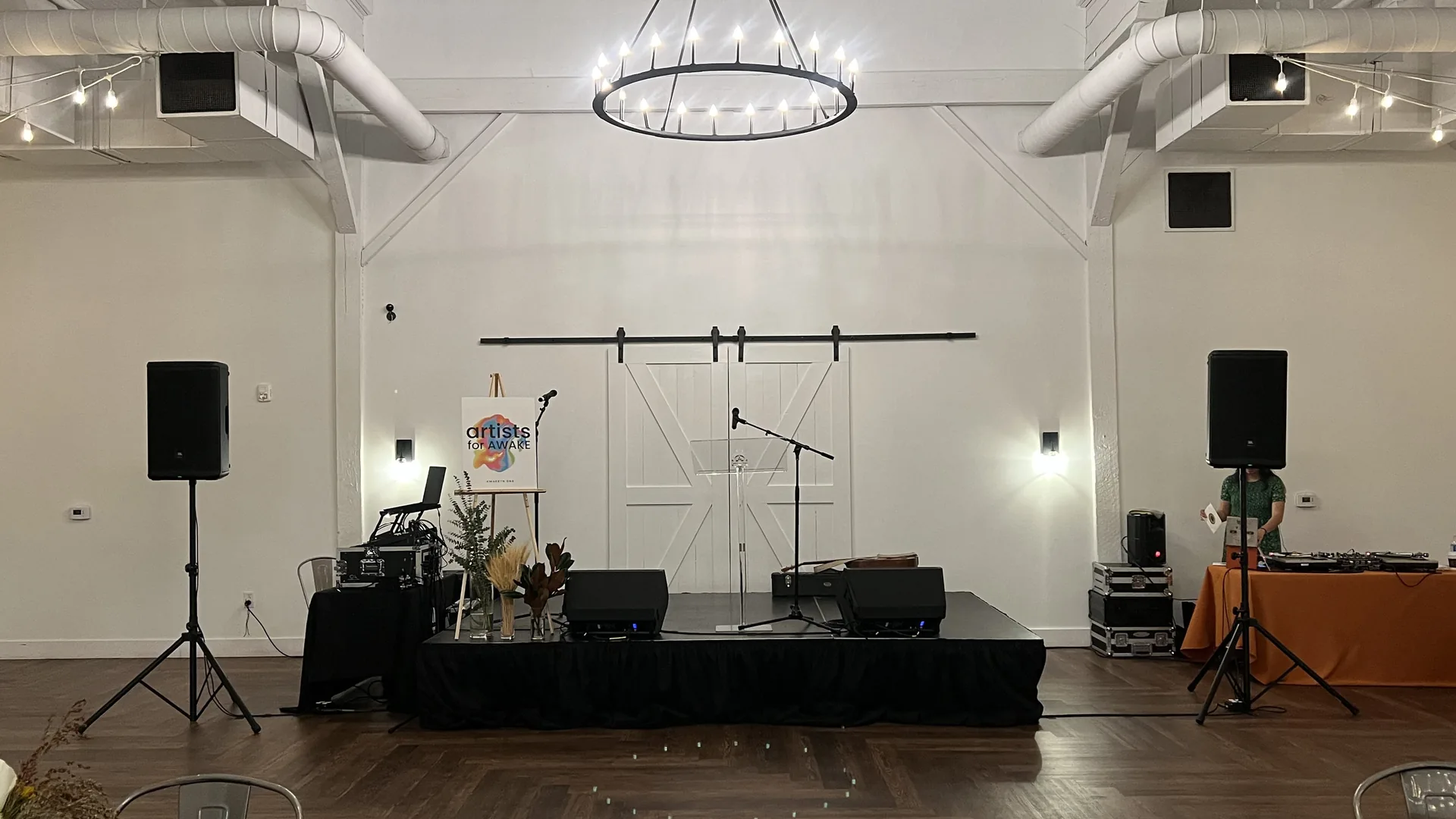 Professional indoor event stage setup featuring microphones and speaker systems