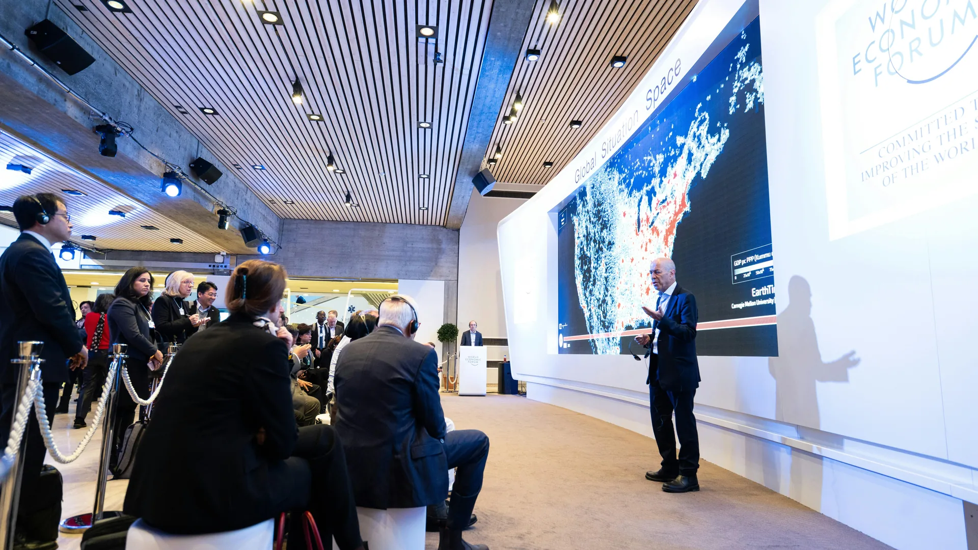 Large presentation space with immersive display wall and integrated AV systems for multi-room global event