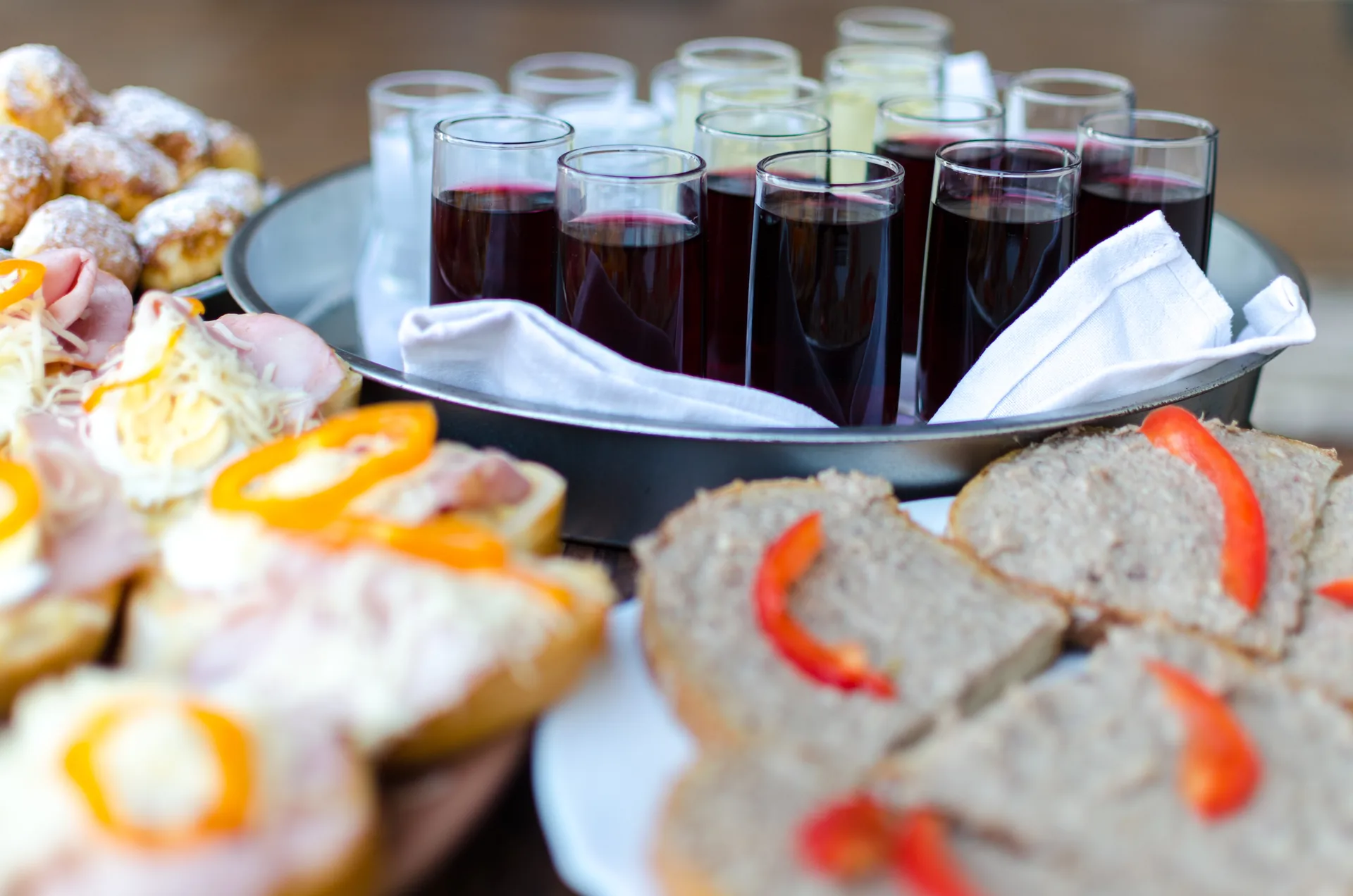 Assorted appetizers and wine glasses arranged on table for event reception