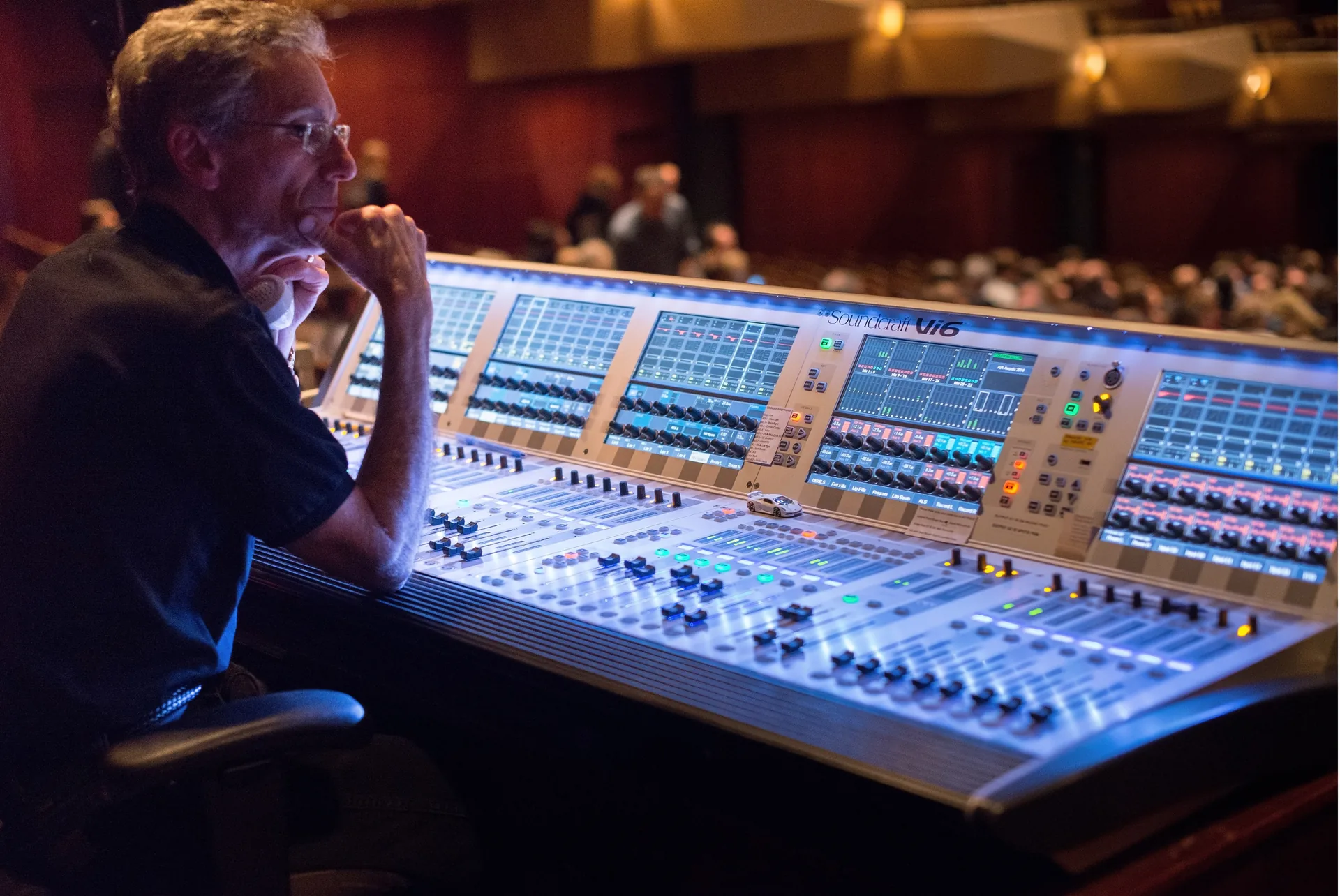 Audio engineer live mixing sound at a corporate event from the front of house position
