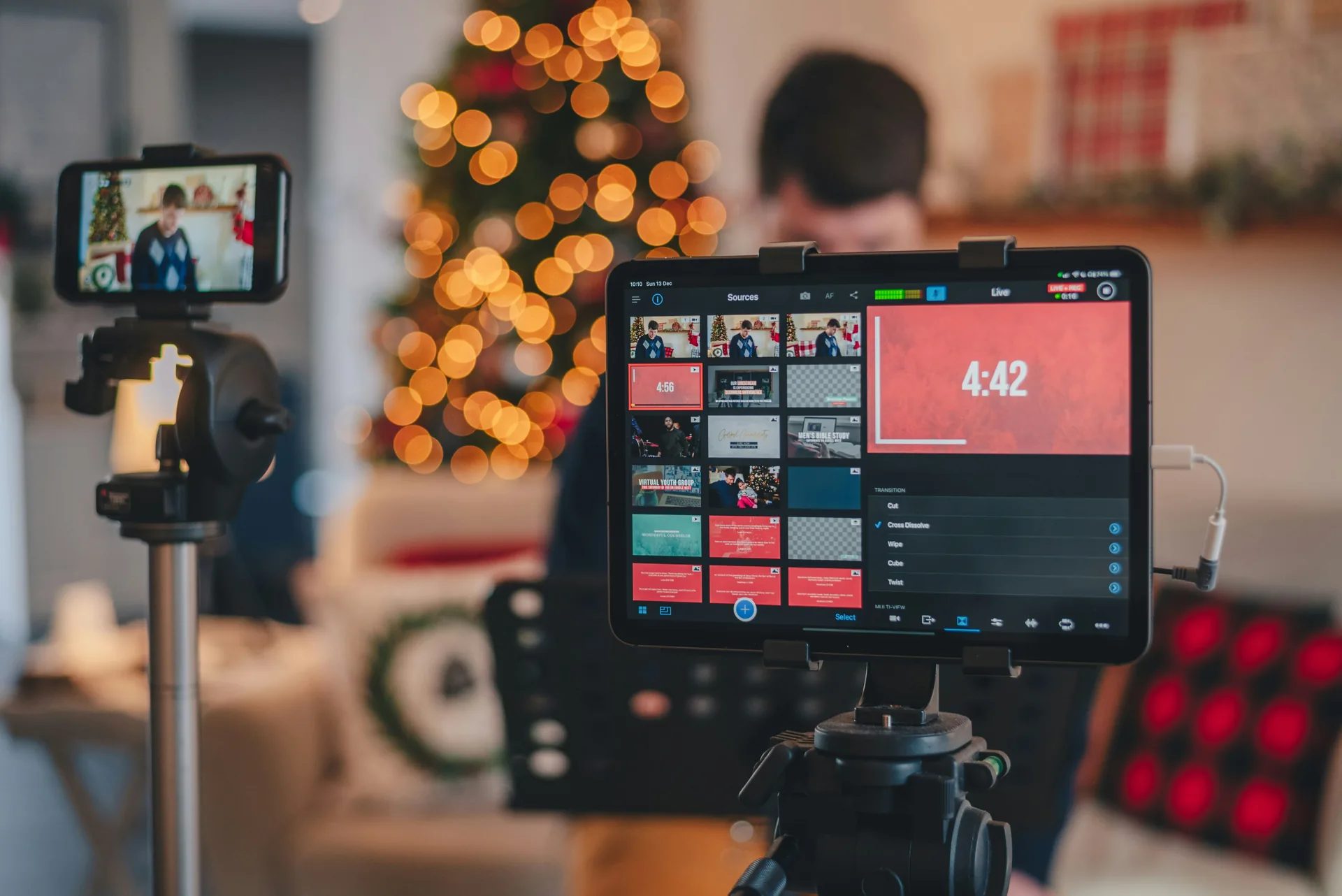 Close-up view of audio mixer and camera equipment configured for live event streaming