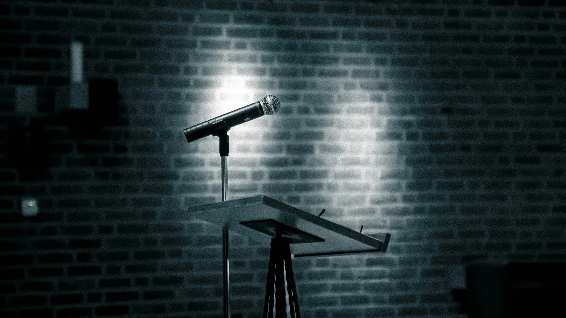 Microphone on podium under stage lighting ready for host or speaker presentation