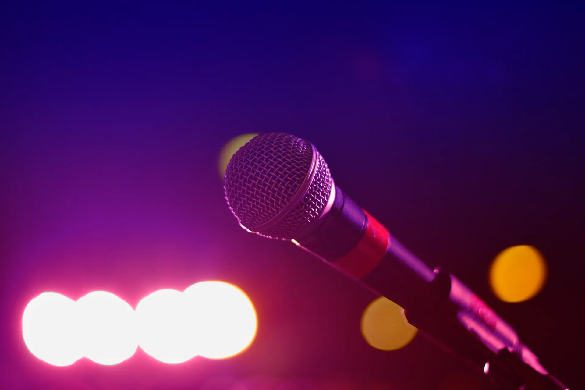 Microphone positioned under stage lighting at live event venue