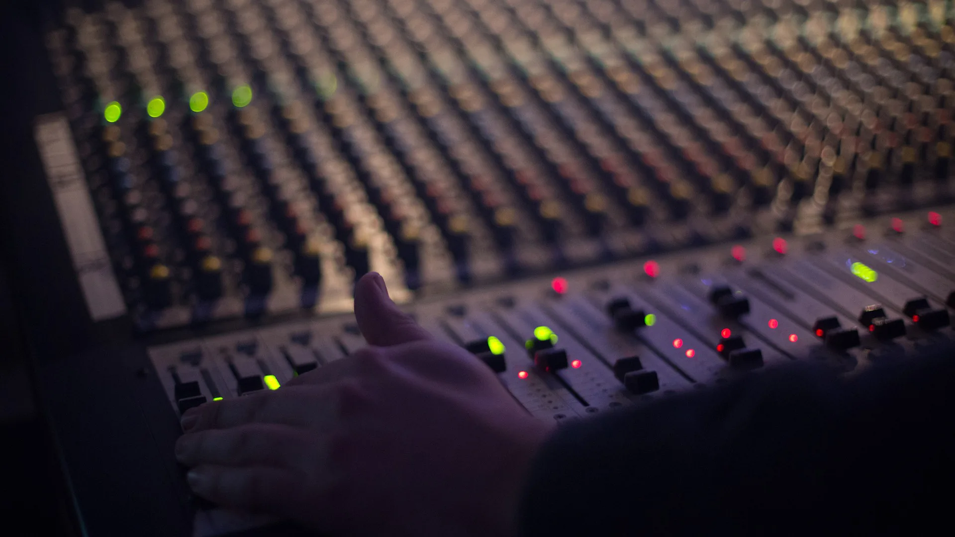 Engineer mixing a live show on a Midas Venice analog mixing console