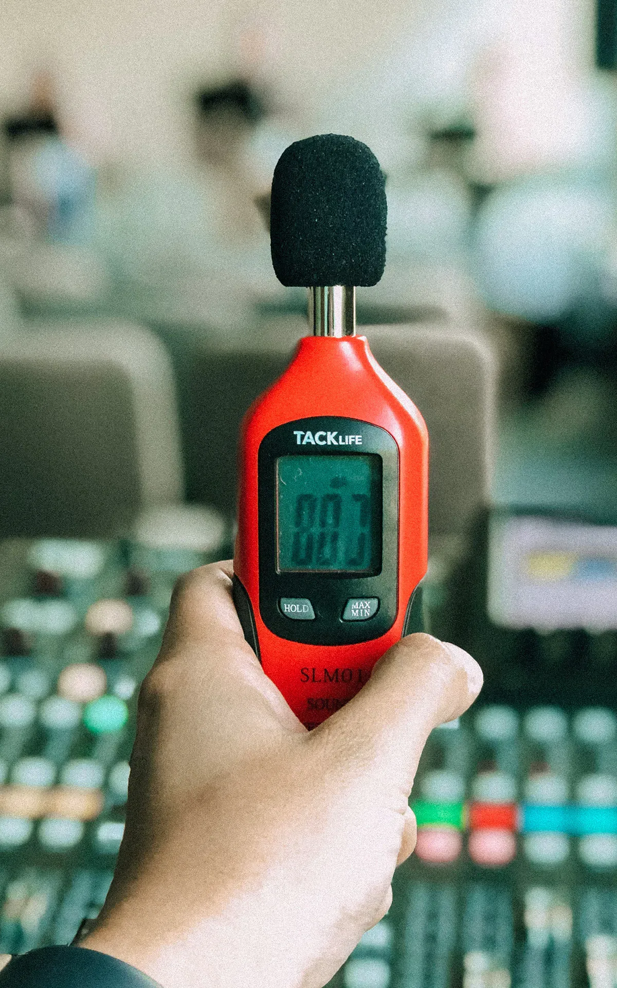 Sound level meter measuring decibel levels at outdoor Nashville event for noise compliance
