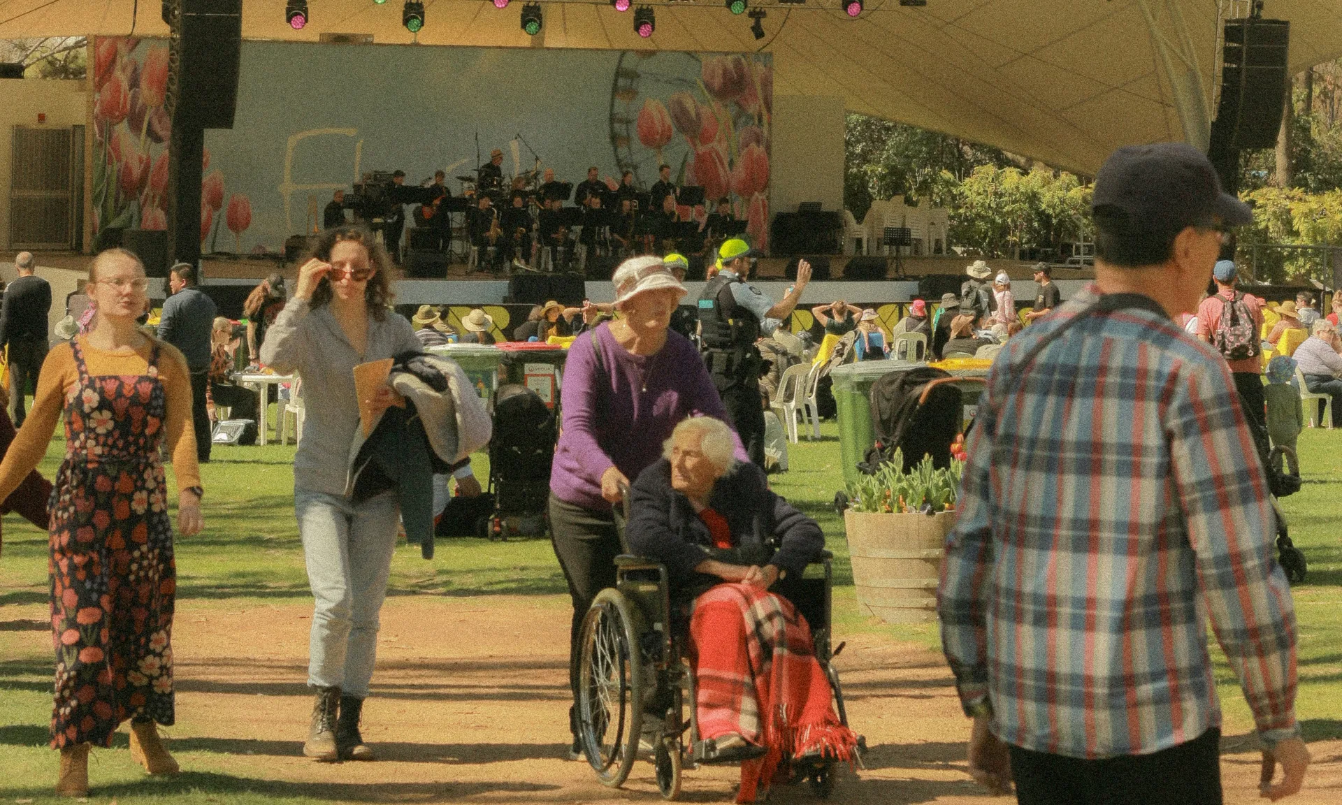 Outdoor community event showing wheelchair accessible pathways and inclusive seating arrangements for all attendees