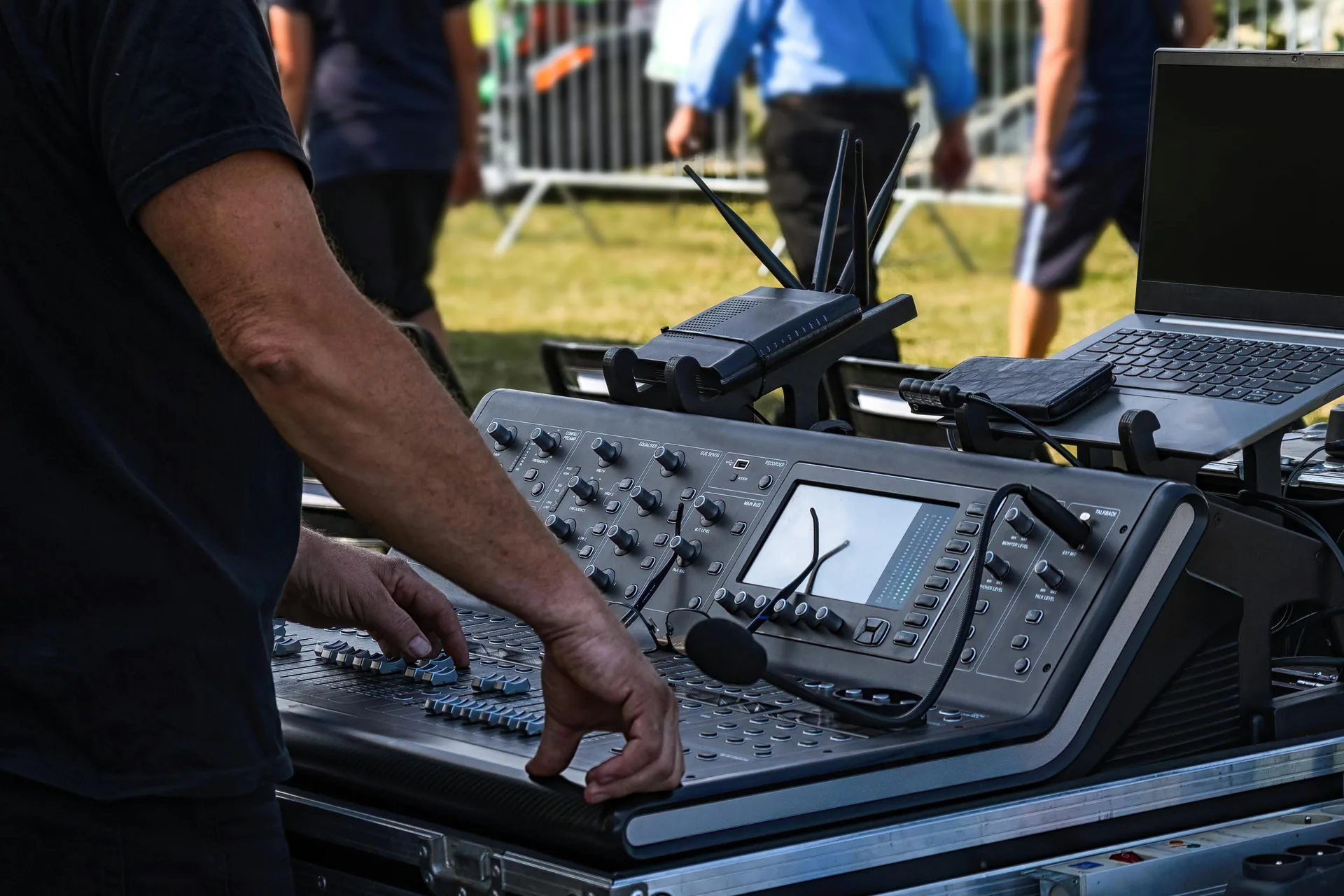 Live outdoor AV setup with digital audio mixer and wireless connectivity for event sound production
