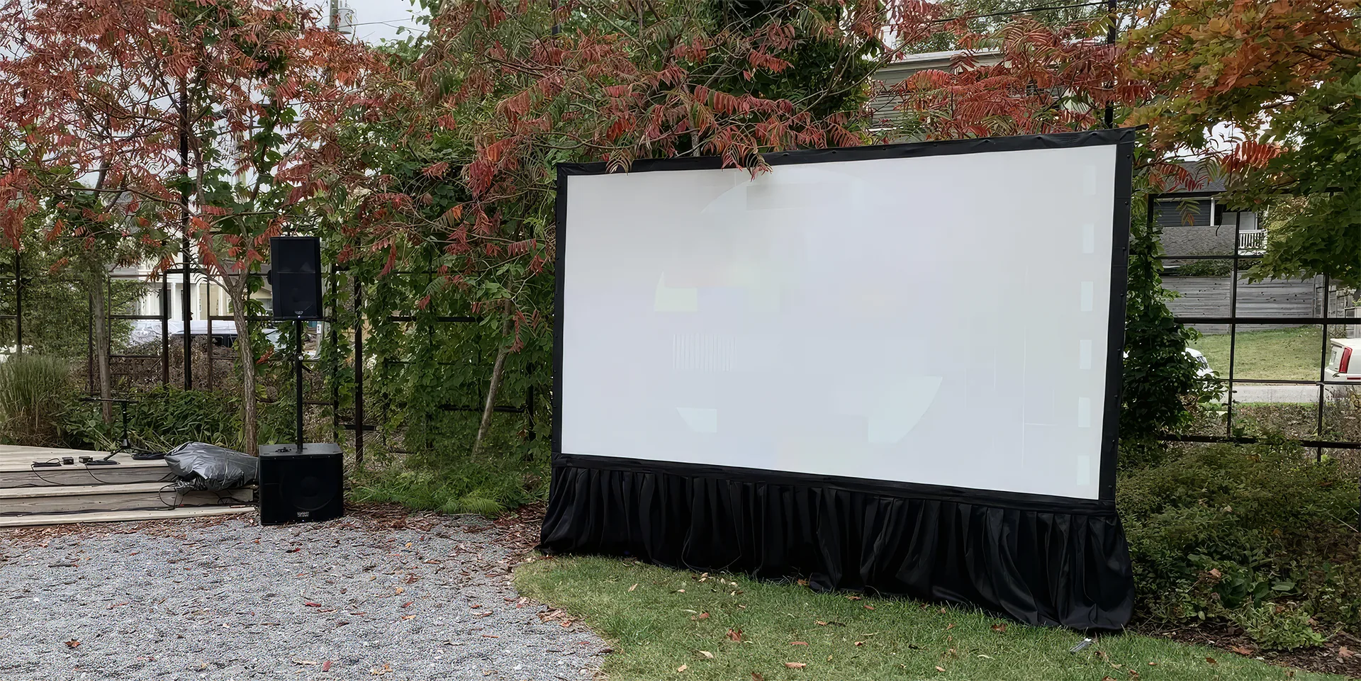 Outdoor projection screen in daylight with a washed-out image, illustrating the limits of daytime event projection.