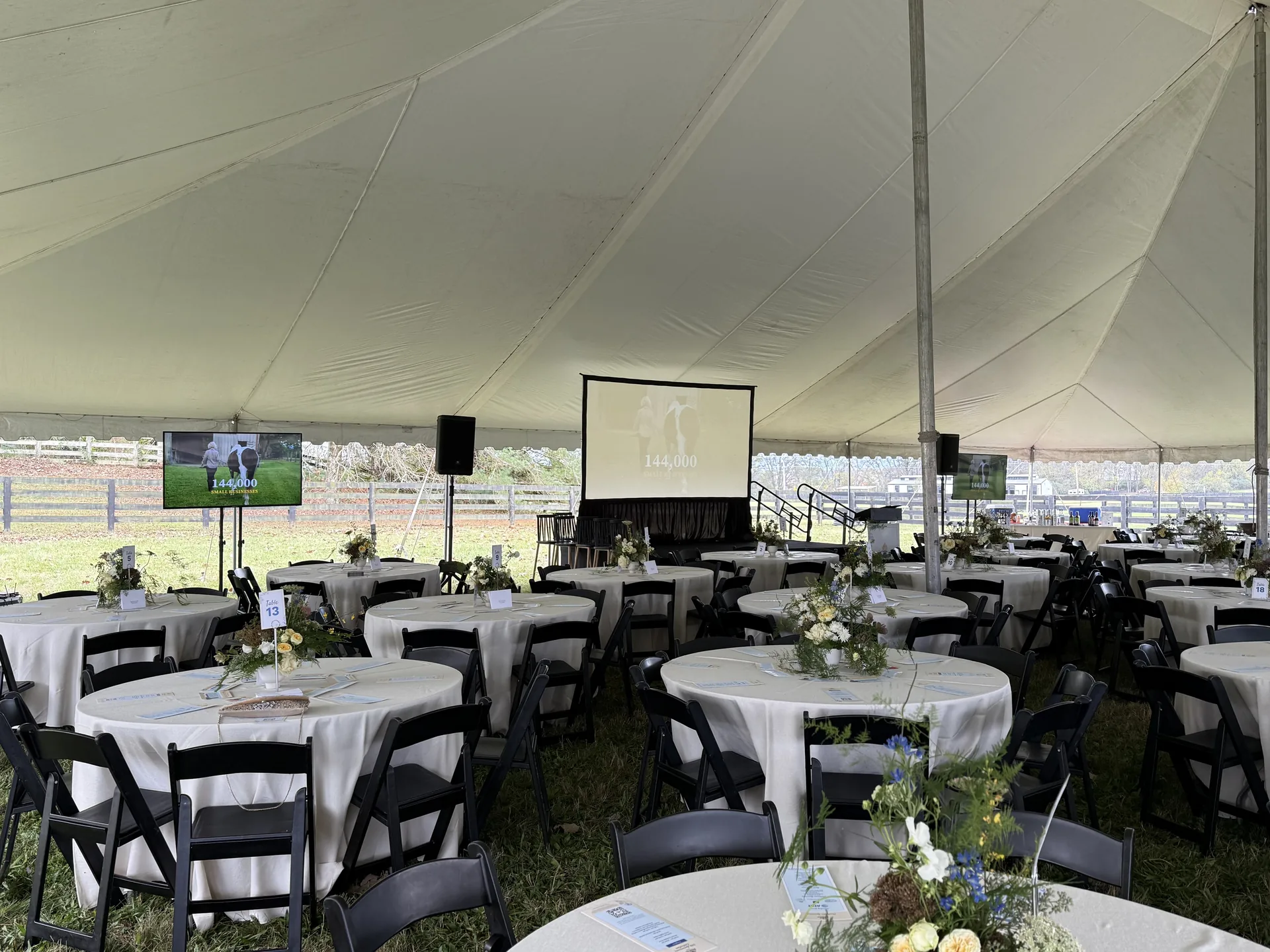 Outdoor wedding tent setup with table layout showing where TV displays would be positioned