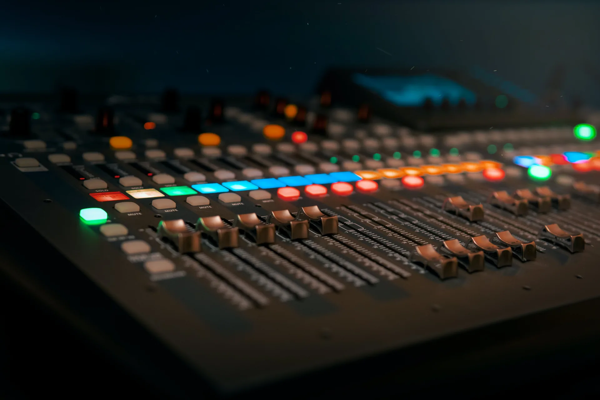 Professional audio mixer soundboard with multiple faders and controls at conference event