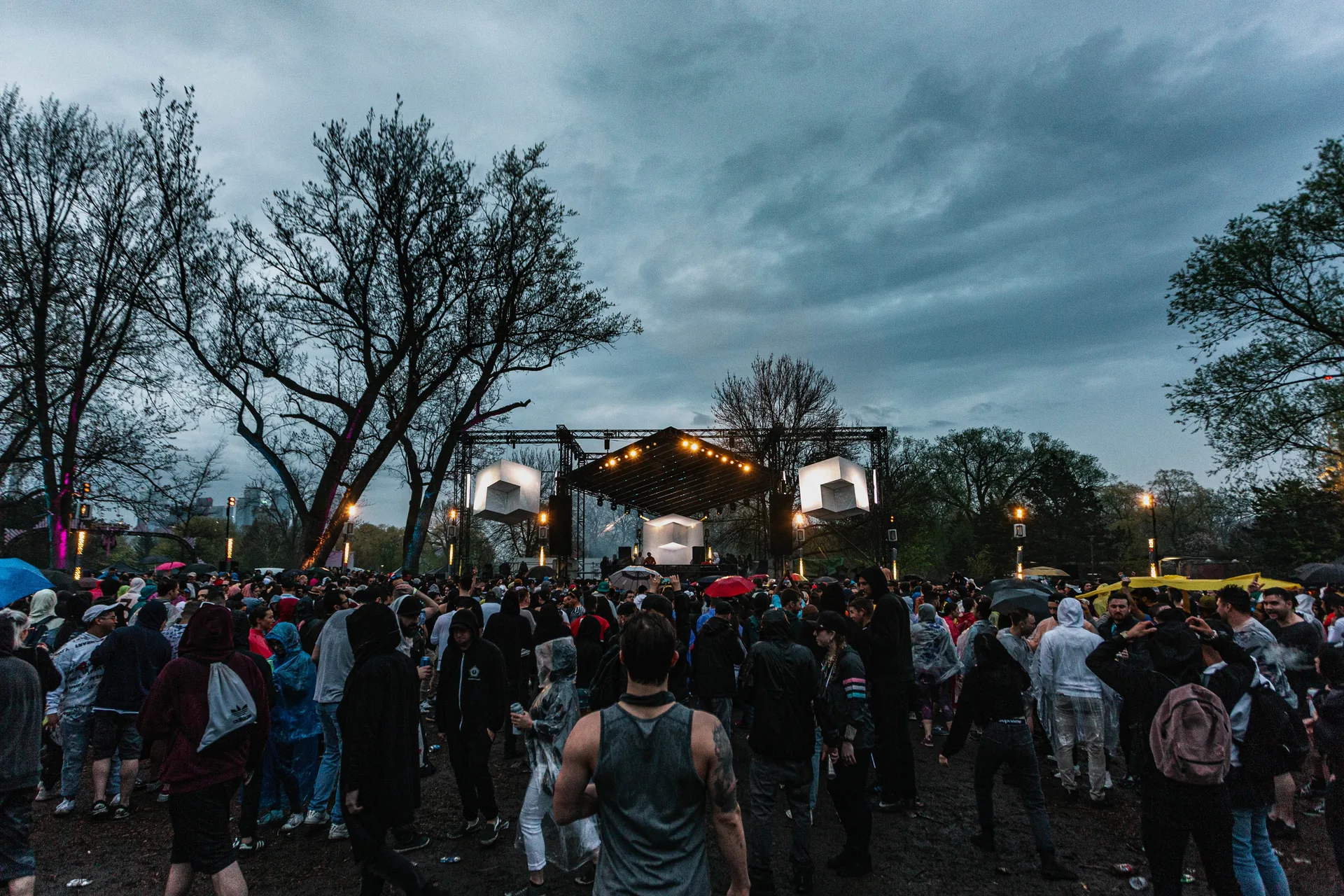 Outdoor concert venue during heavy rain demonstrating weather contingency
