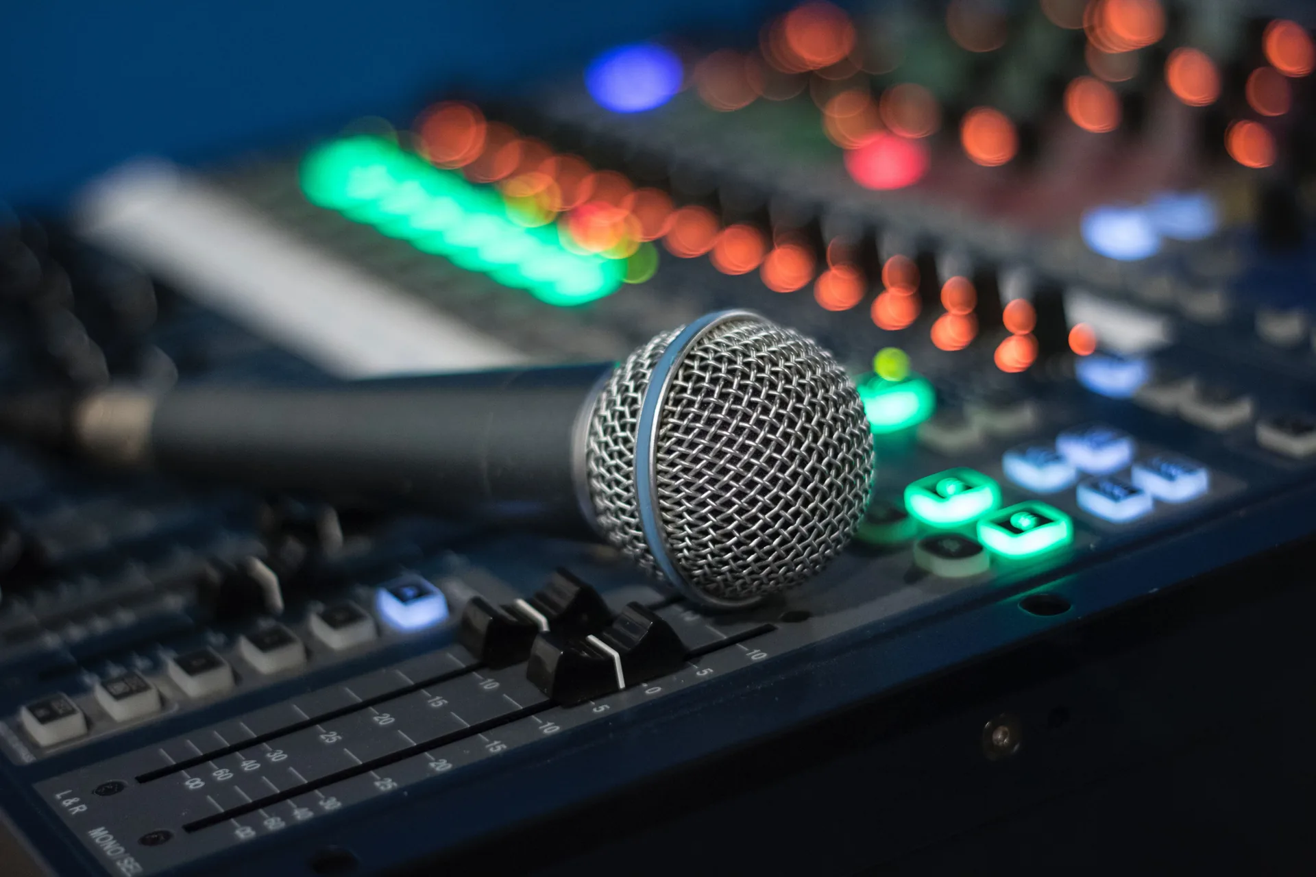 Professional microphone mounted on large audio mixing console