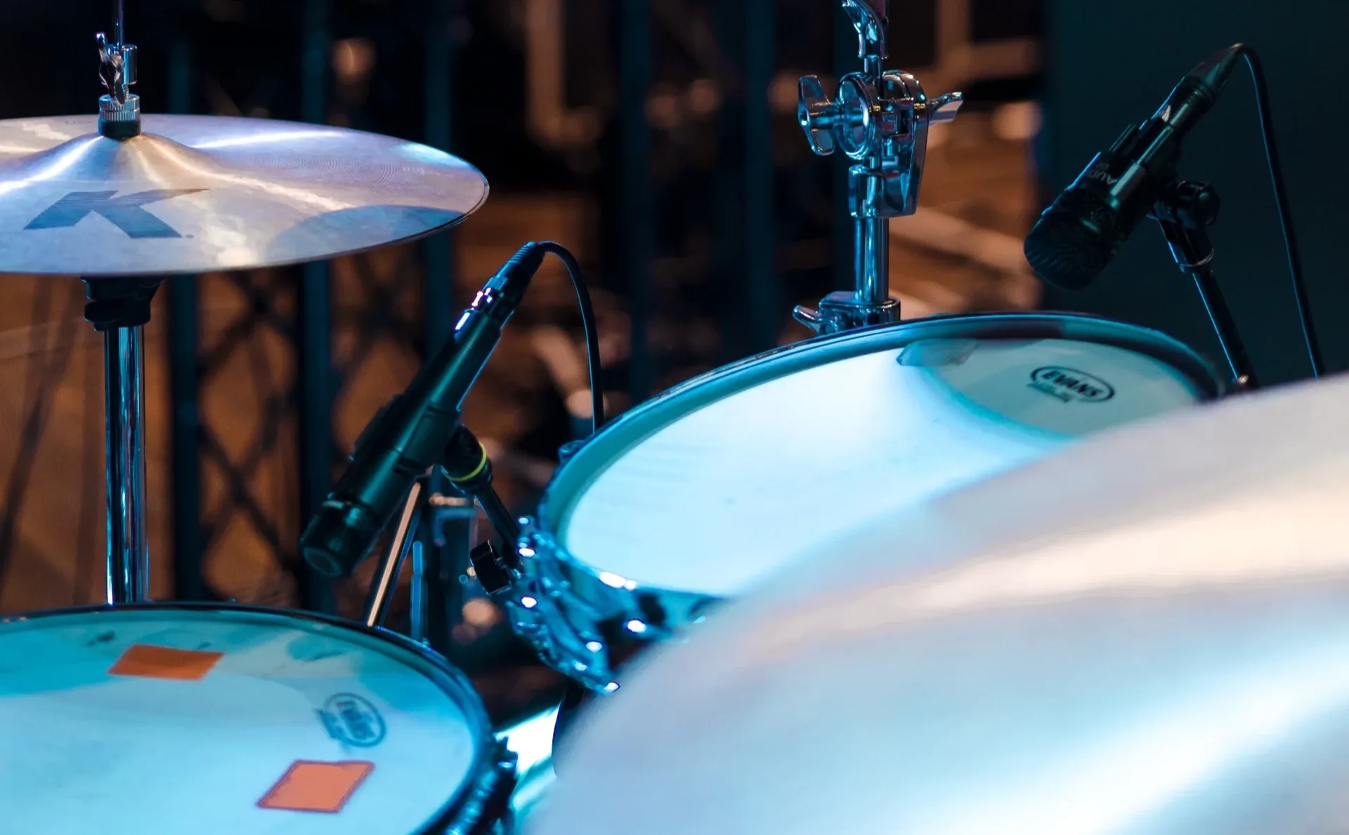Drum kit with dynamic microphones positioned on toms, snare and cymbals for live performance capture