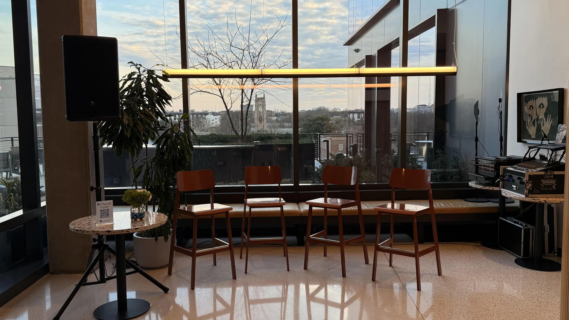 Modern Nashville breakout room with panel discussion setup including speakers, mixer and seating