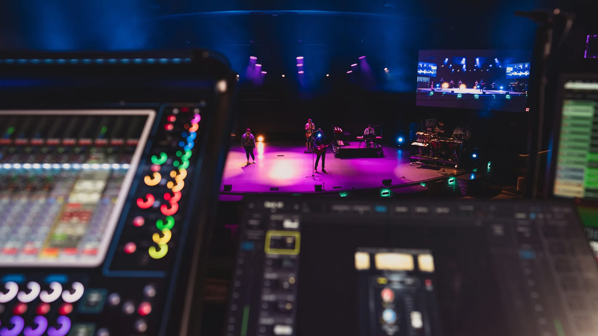 Soundboard operator monitoring live stage audio levels during tech rehearsal