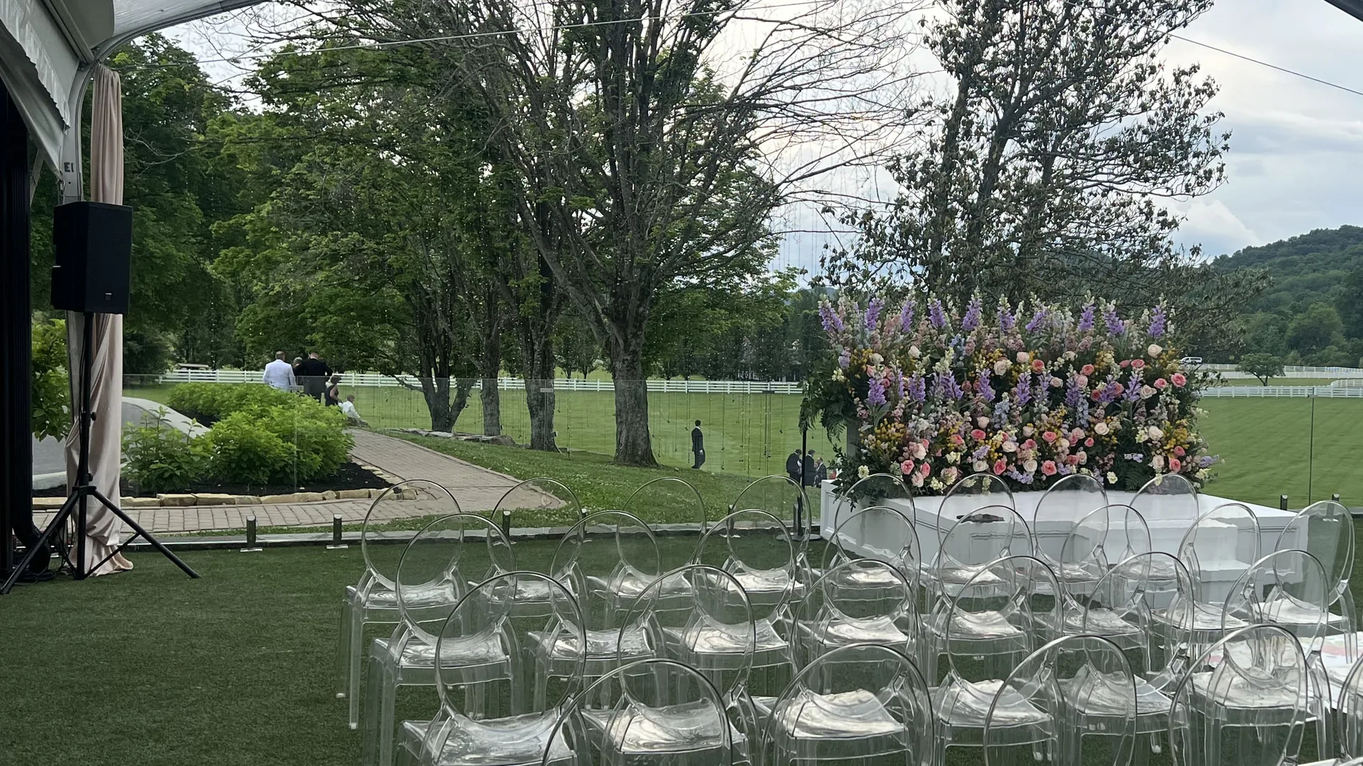 Portable PA speaker system set up under clear tent with transparent guest seating